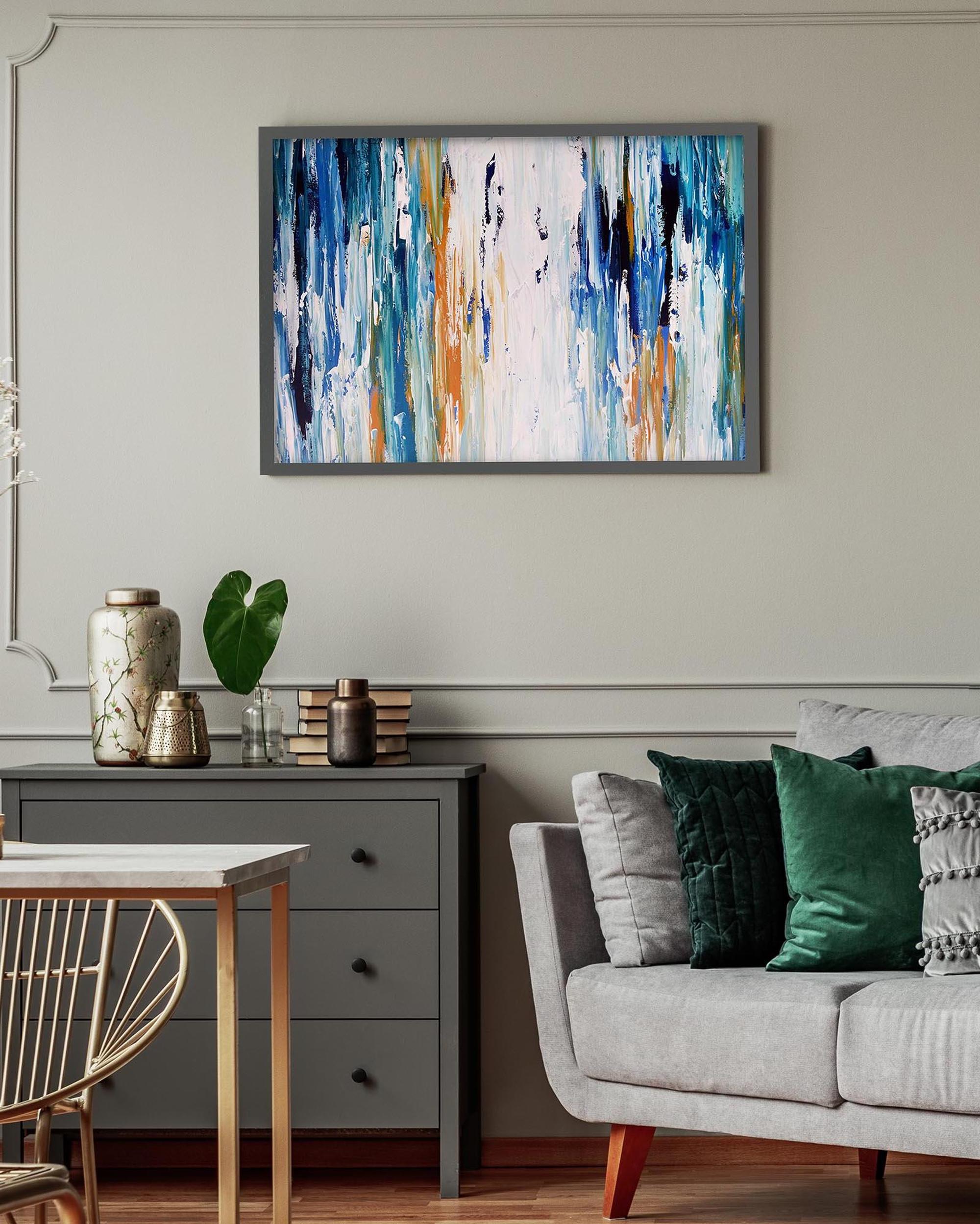 Living room with a gray sofa, wooden side table, and abstract painting on the wall.