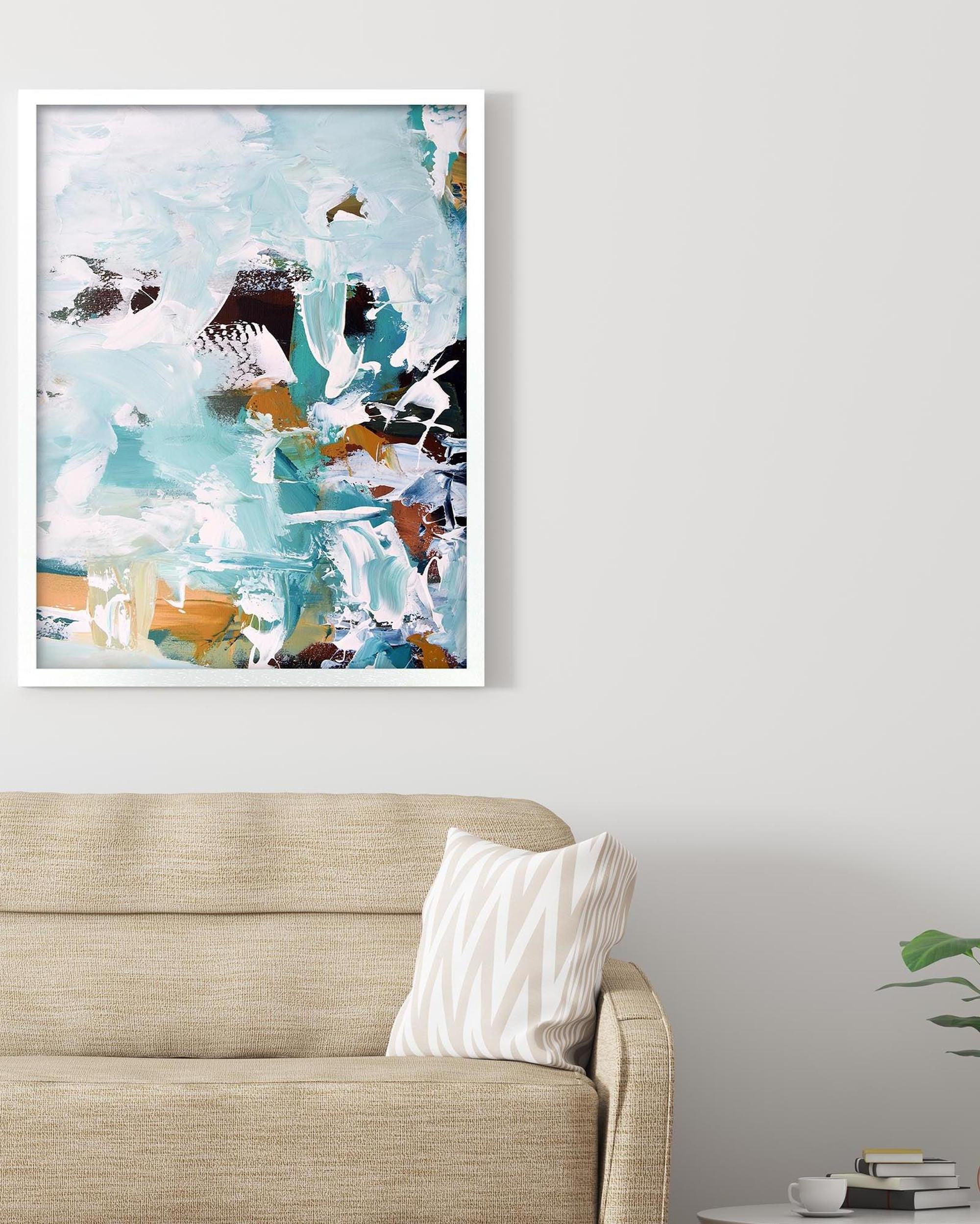 Abstract art print on a wall above a sofa