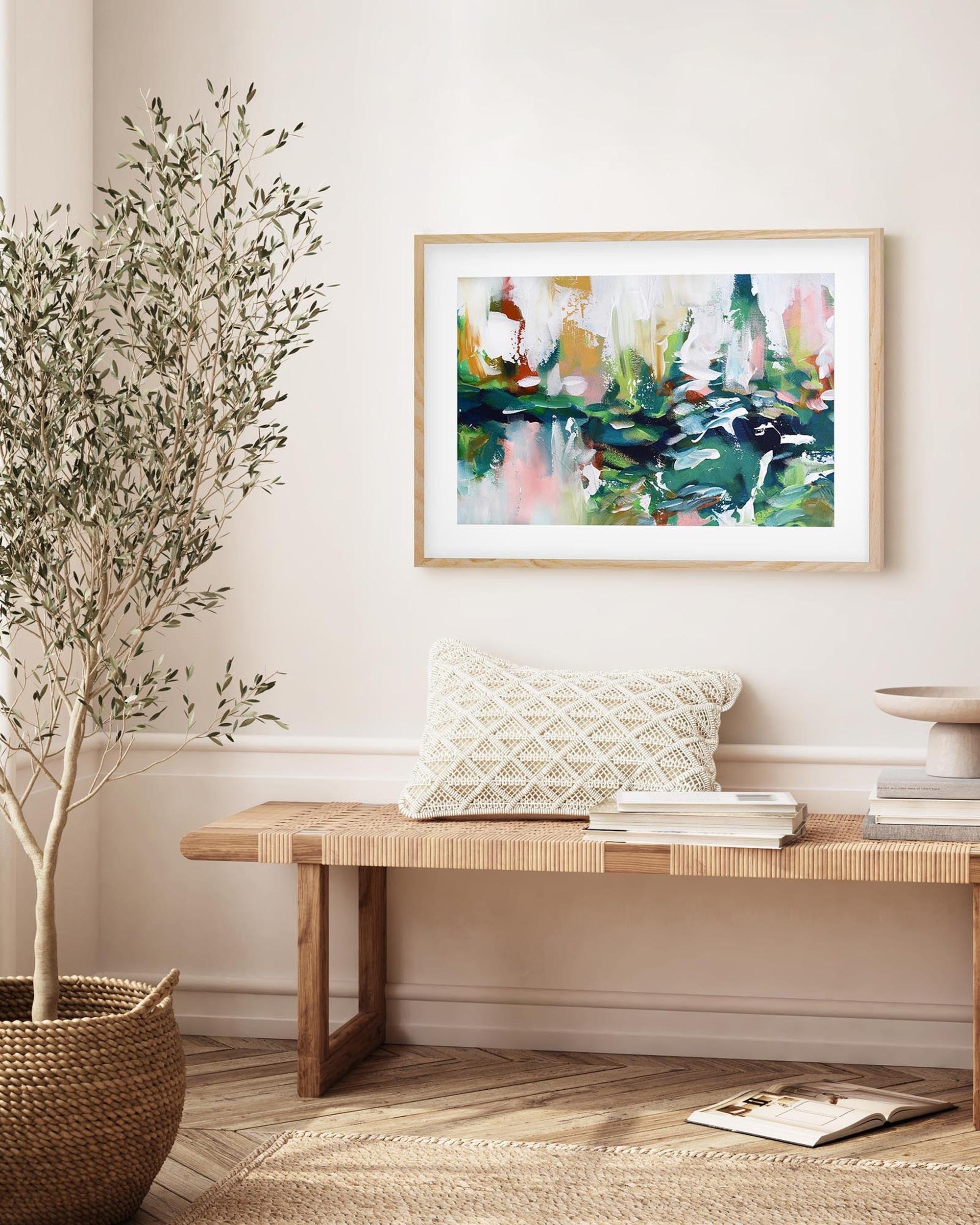 Living room with a wooden bench, plant, and abstract painting on the wall.