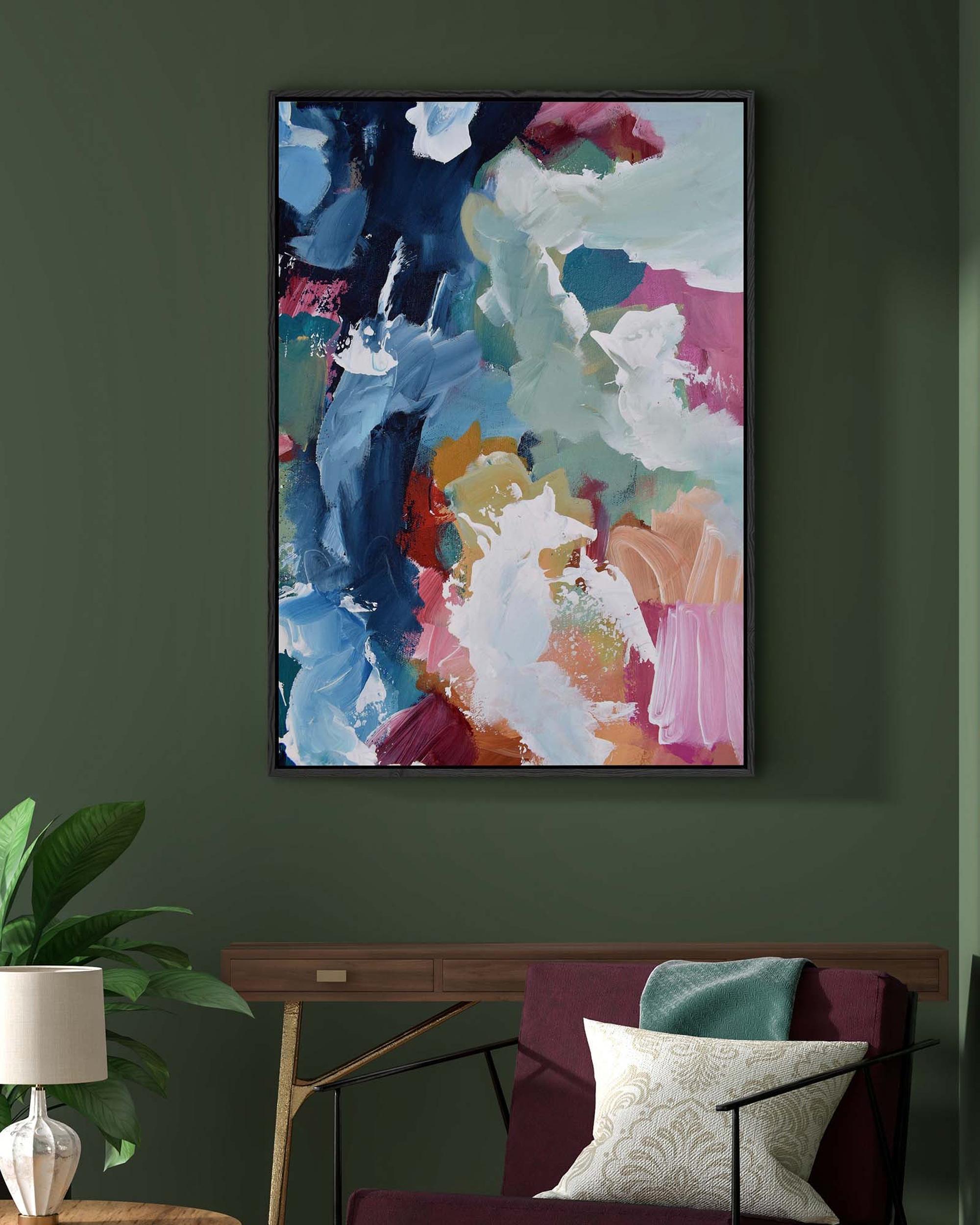 Colorful abstract painting on a dark green wall above a sofa with decorative pillows.