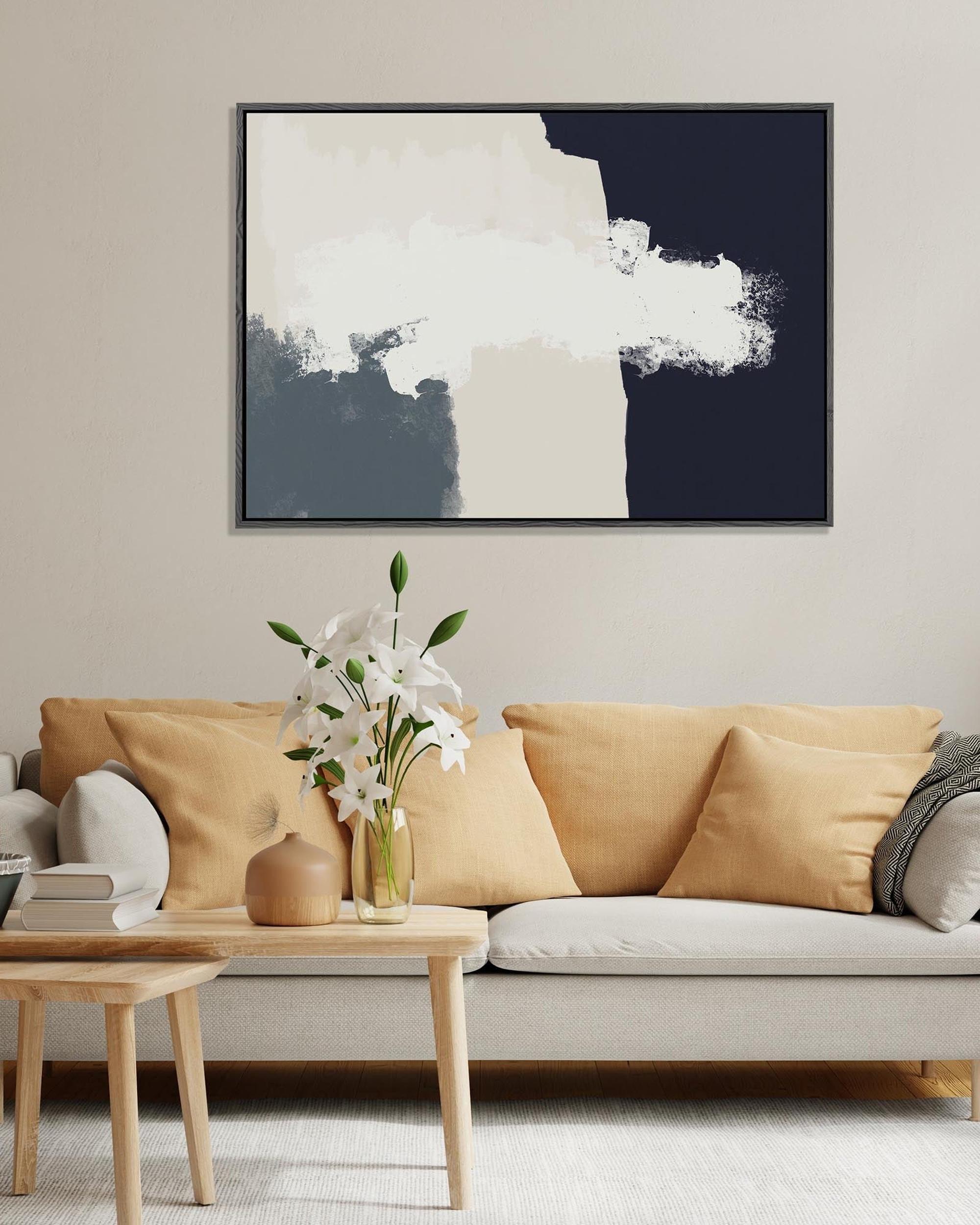 Living room with a beige sofa, coffee table, and abstract art on the wall.