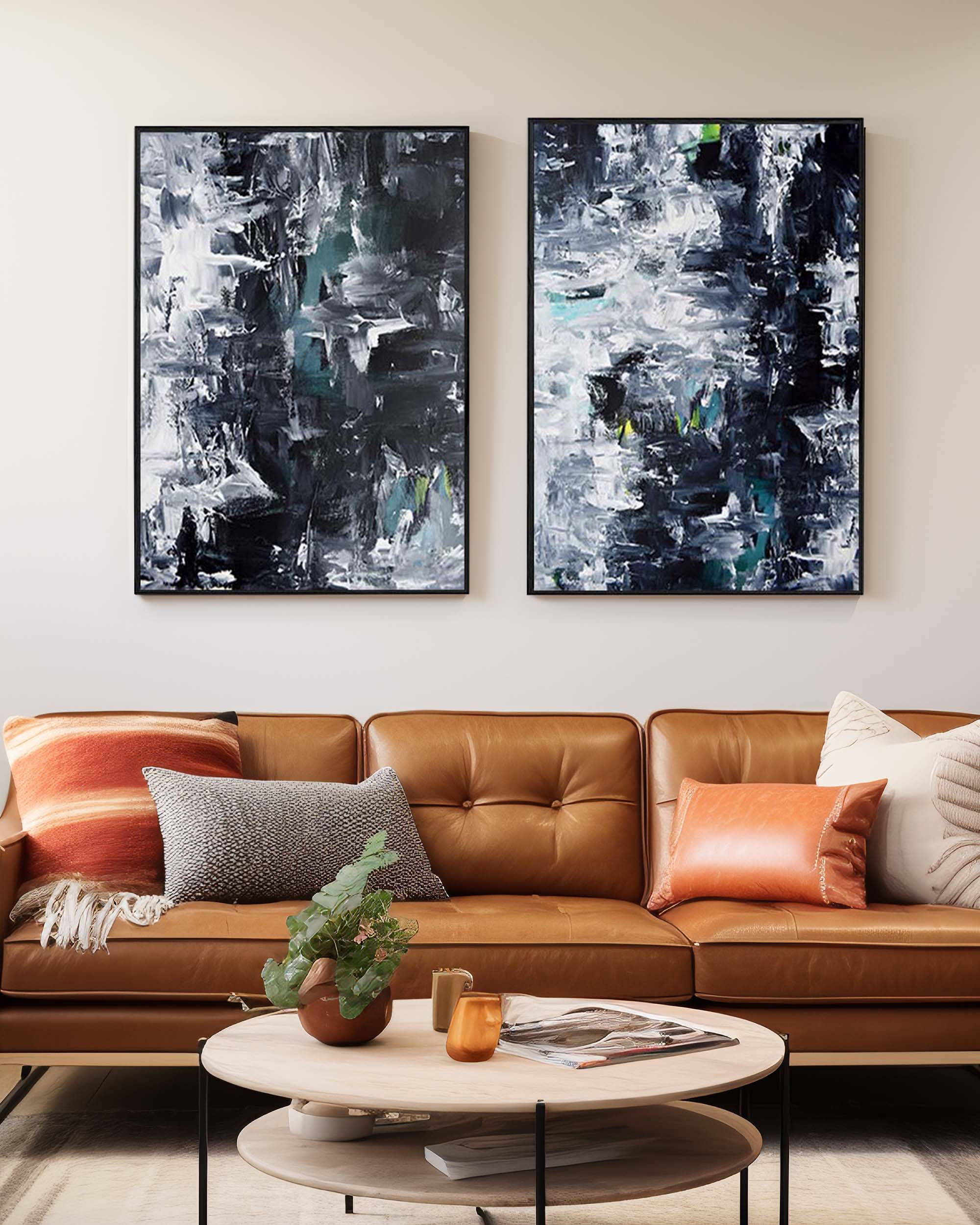 Modern living room with a brown leather sofa, abstract art on the wall, and a round coffee table.