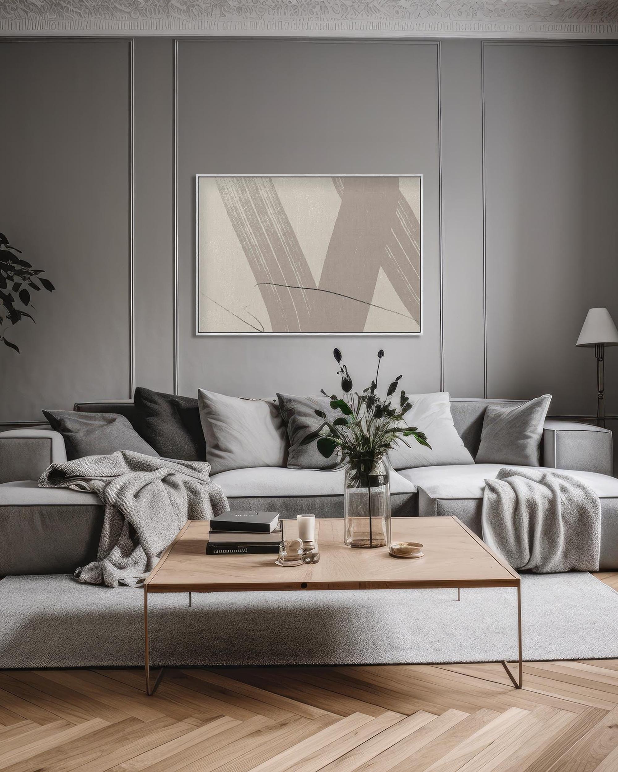 Modern living room with a gray sectional sofa, wooden coffee table, and abstract art on the wall.