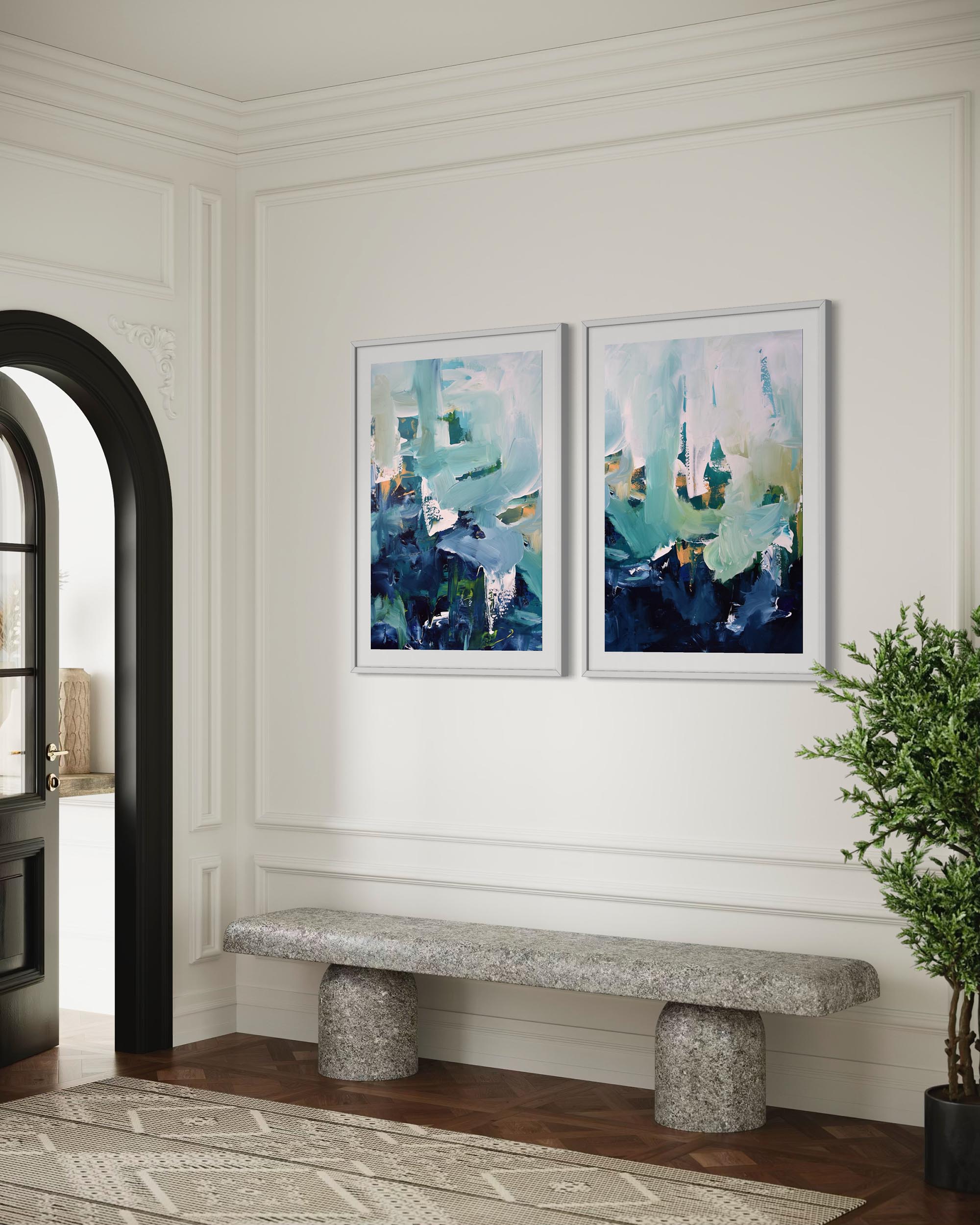 Two abstract art pieces on a wall above a stone bench in a room with a plant.