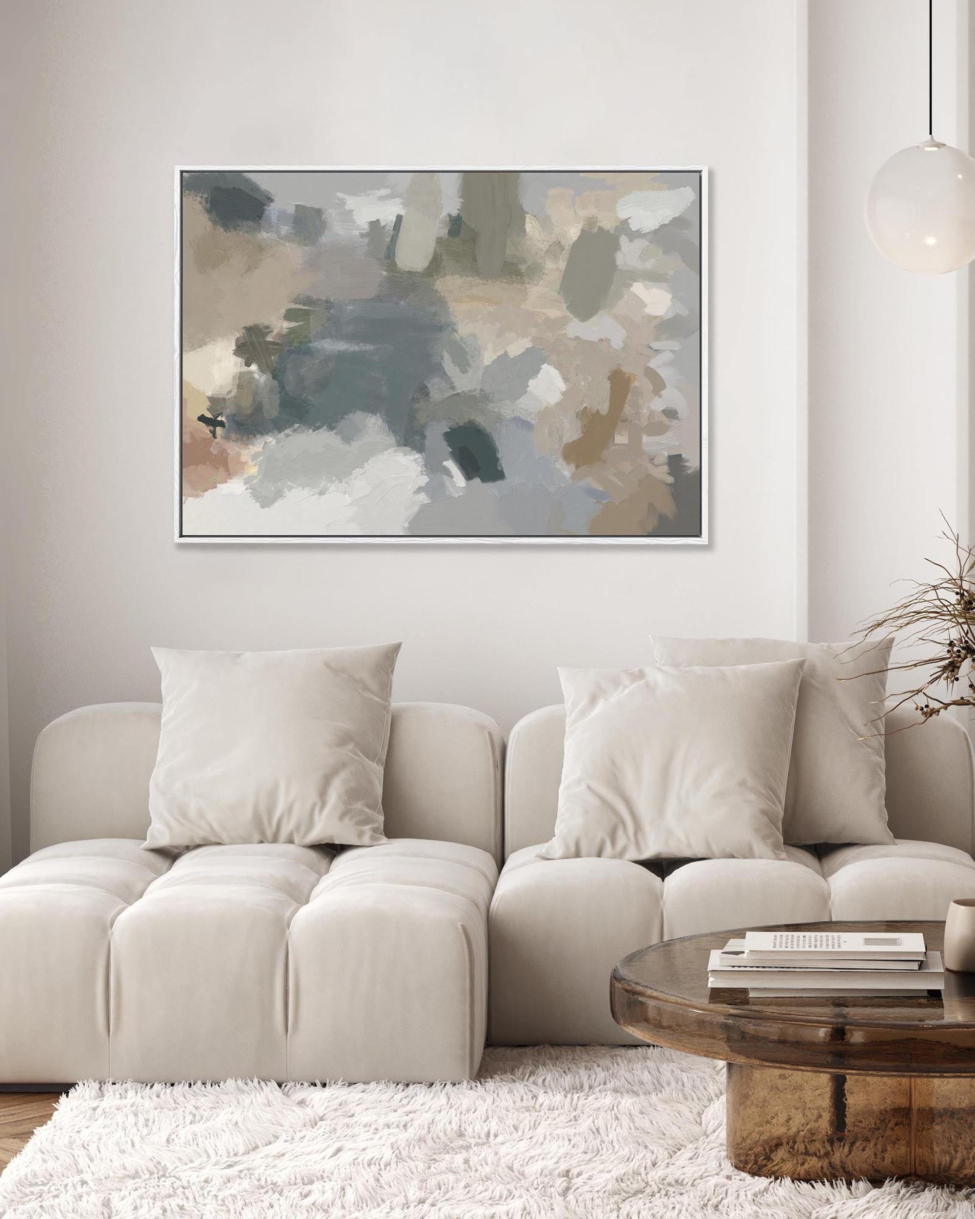 Beige sectional sofa with a wooden coffee table and abstract art on the wall in a living room.