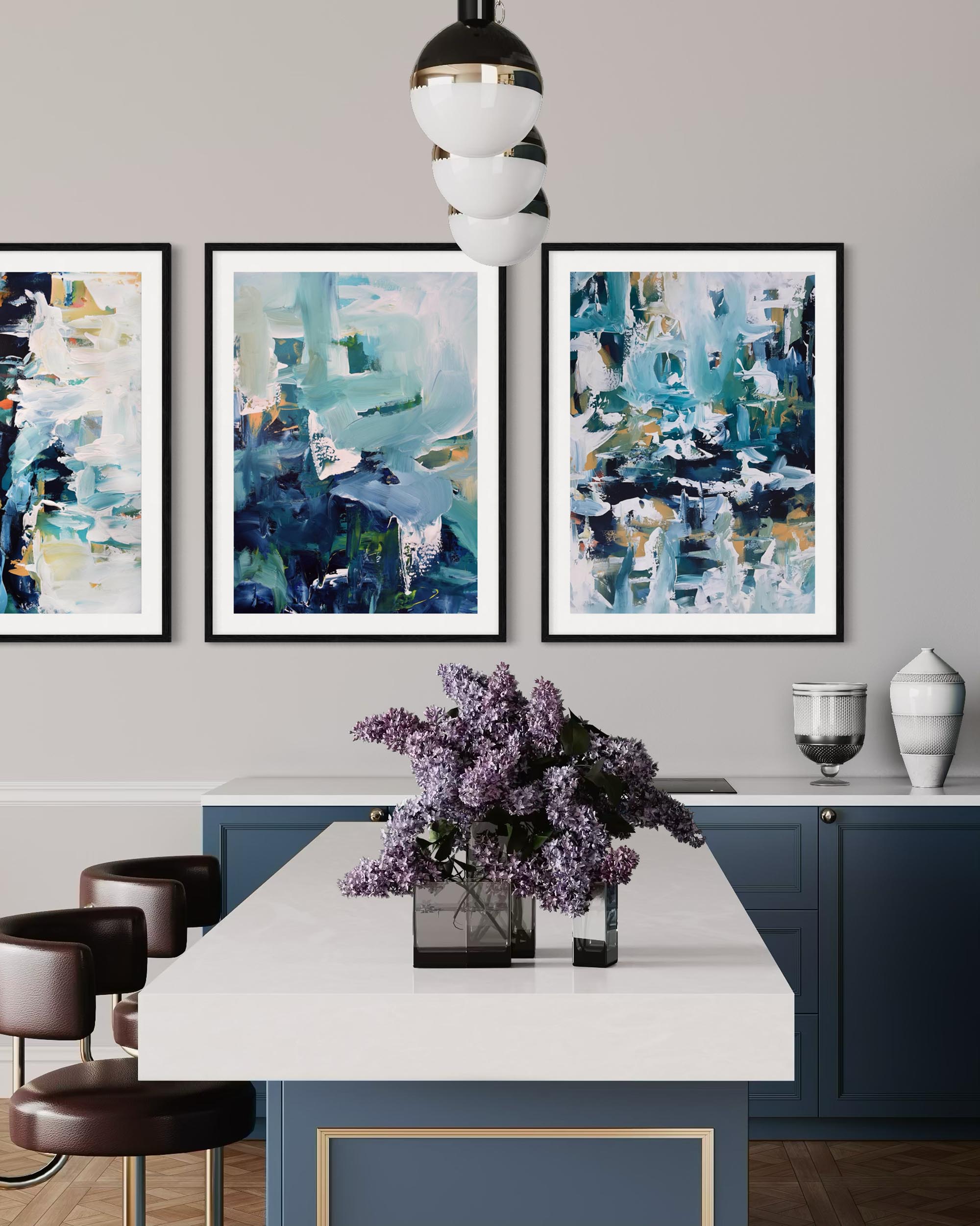 Modern kitchen interior with abstract art on the wall and a table with flowers.