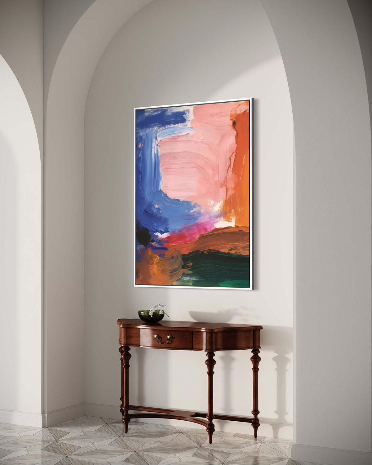 Colorful abstract painting on a wall above a wooden console table in a room with arched doorways.
