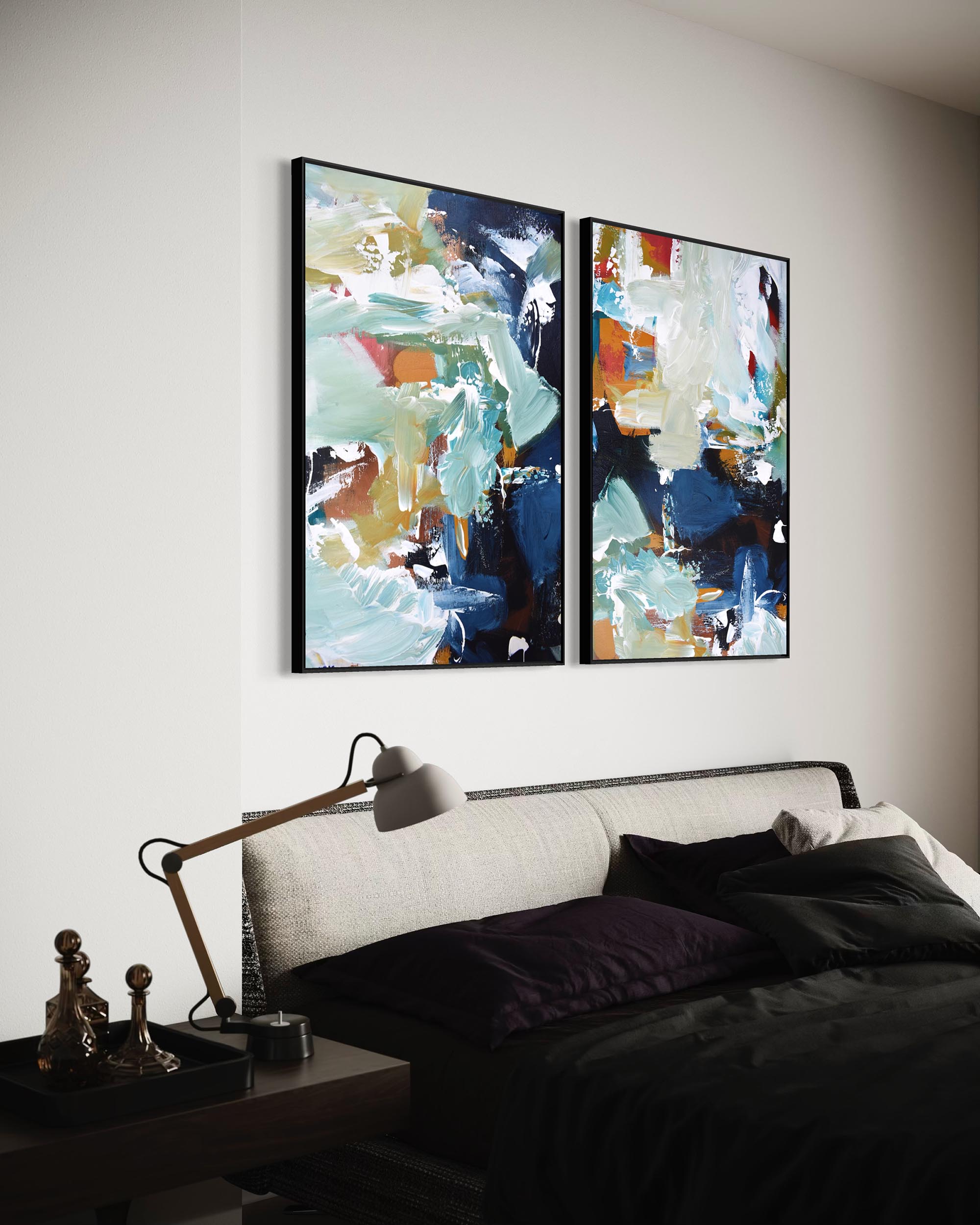 Two abstract paintings above a bed in a bedroom setting.