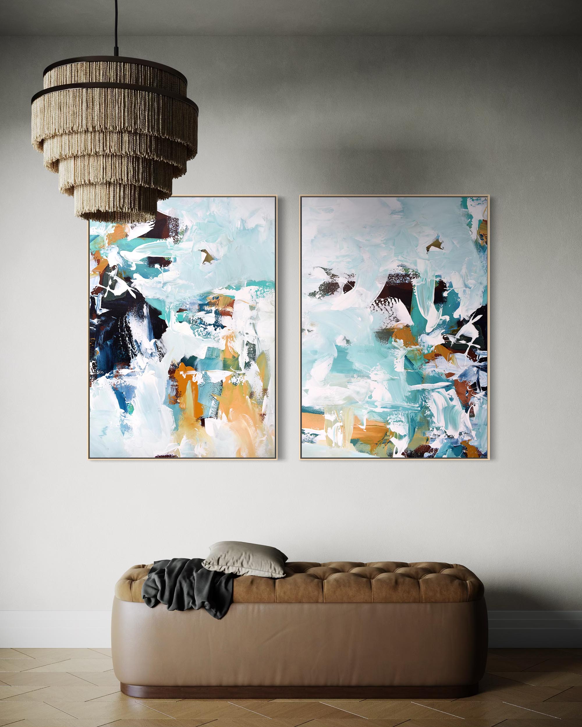 Two abstract paintings on a wall above a brown sofa with a textured ceiling light fixture.