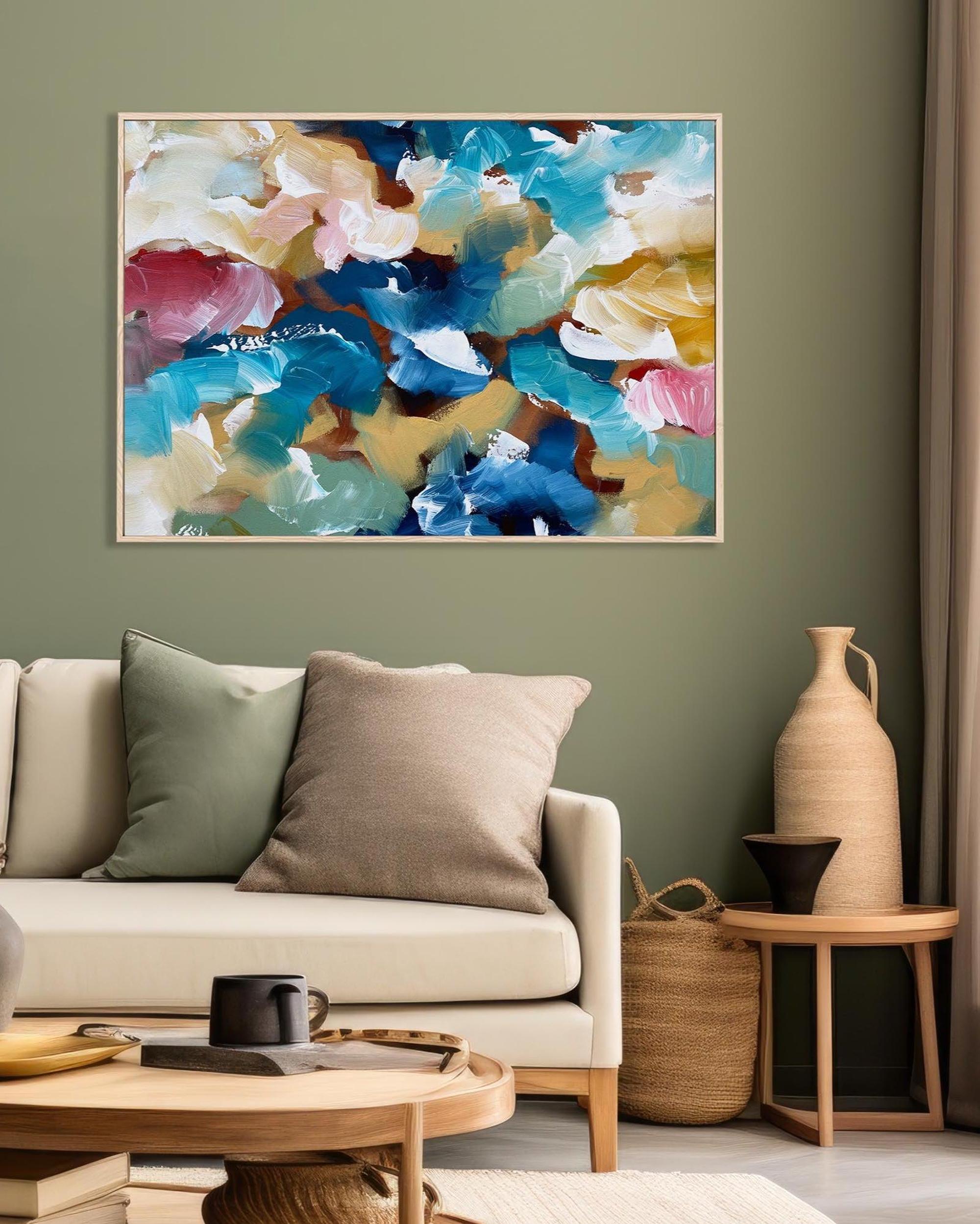 Living room with a colorful abstract painting on the wall, beige sofa, and decorative items.