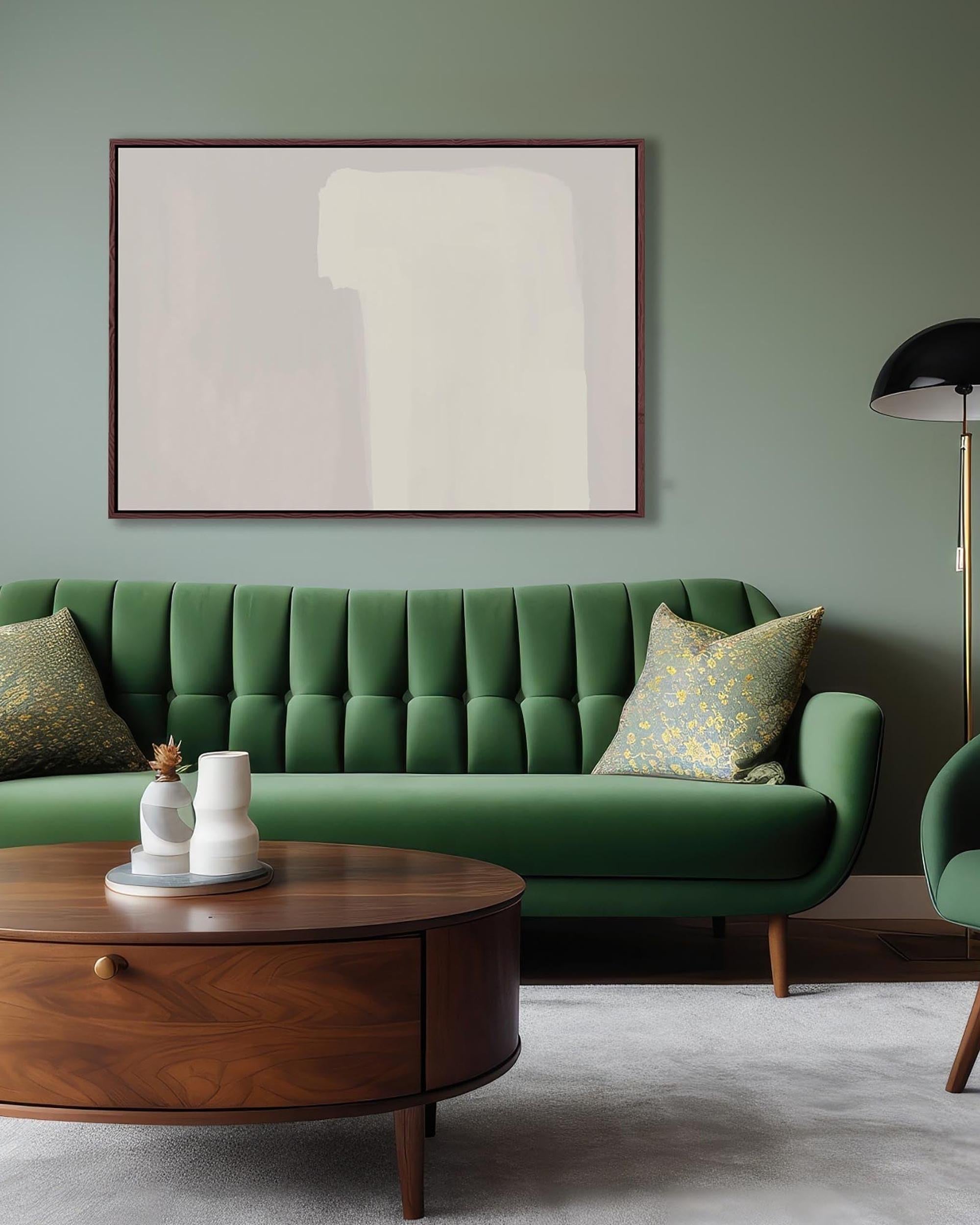 Green sofa in a living room with abstract art on the wall and a wooden coffee table.