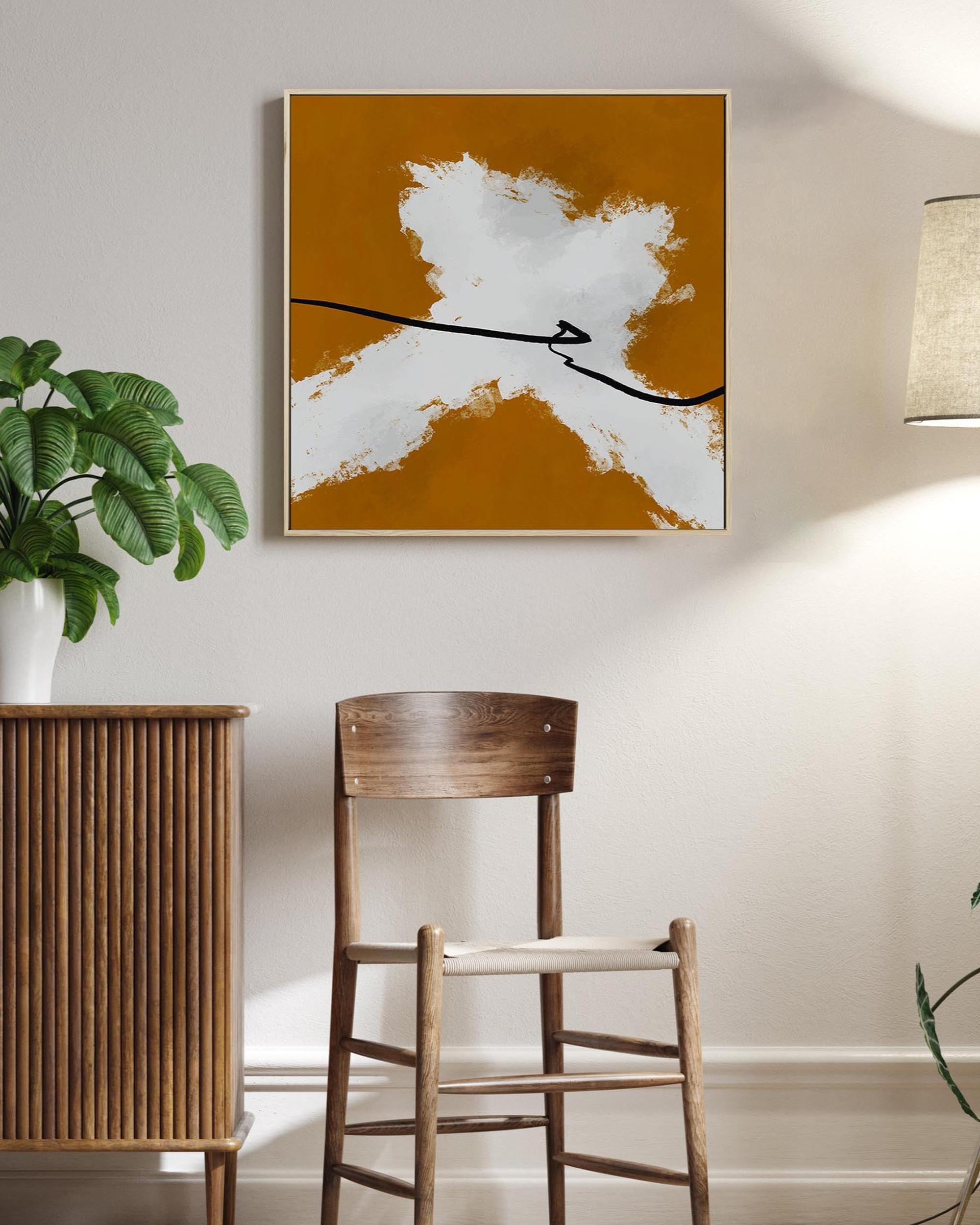 Abstract art piece on a wall above a wooden chair in a room with plants and a lamp.