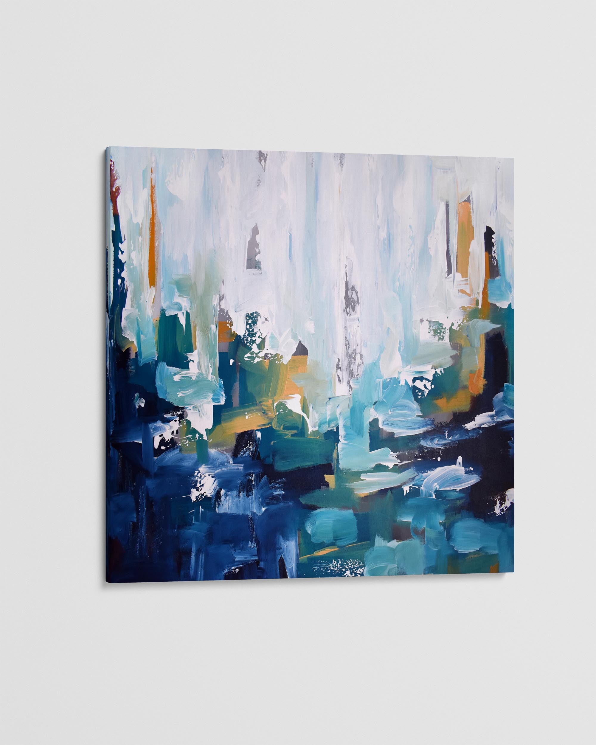 Abstract painting with blue, green, and orange hues on a white wall