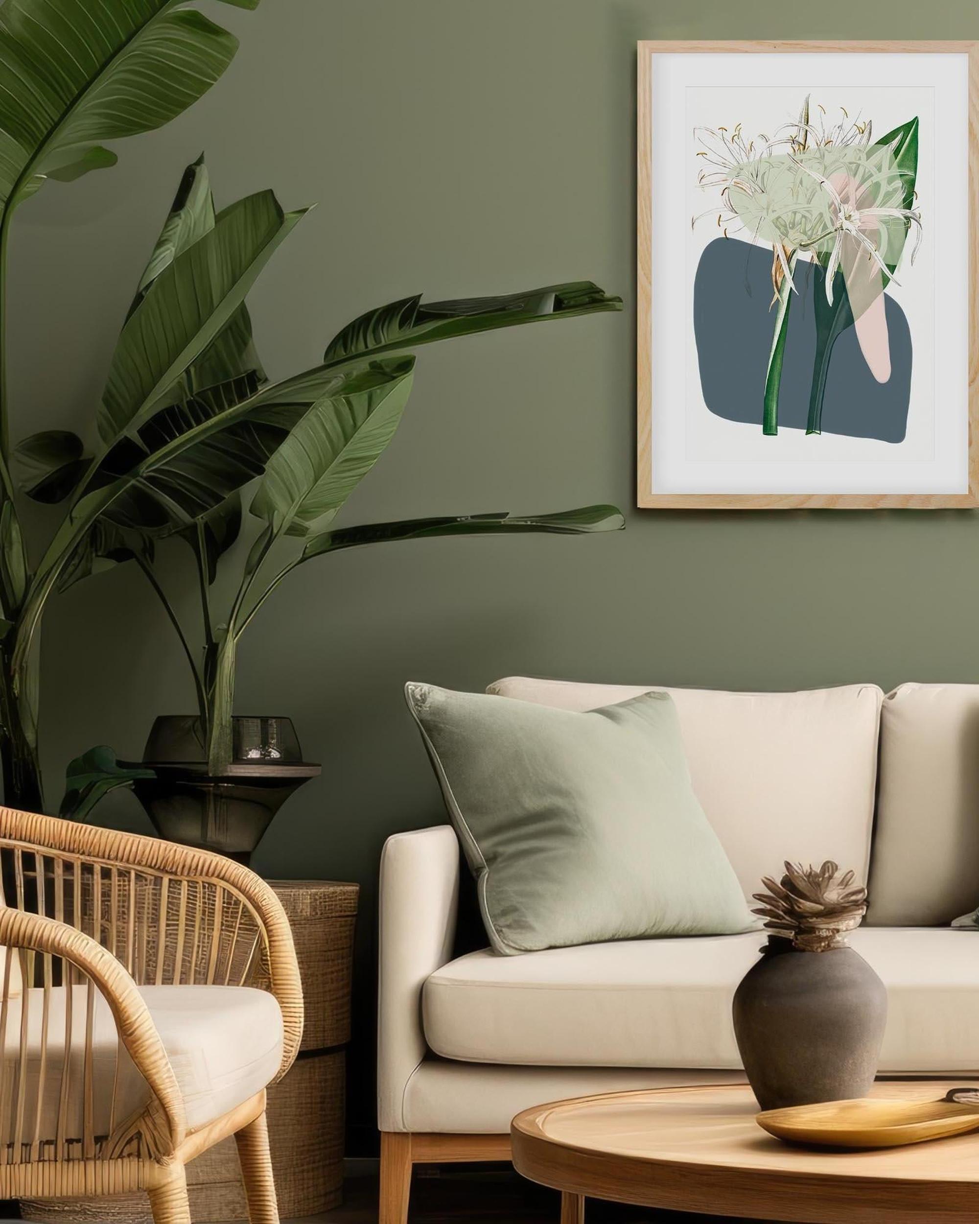 Living room with beige sofa, wicker chair, and framed artwork on a green wall.