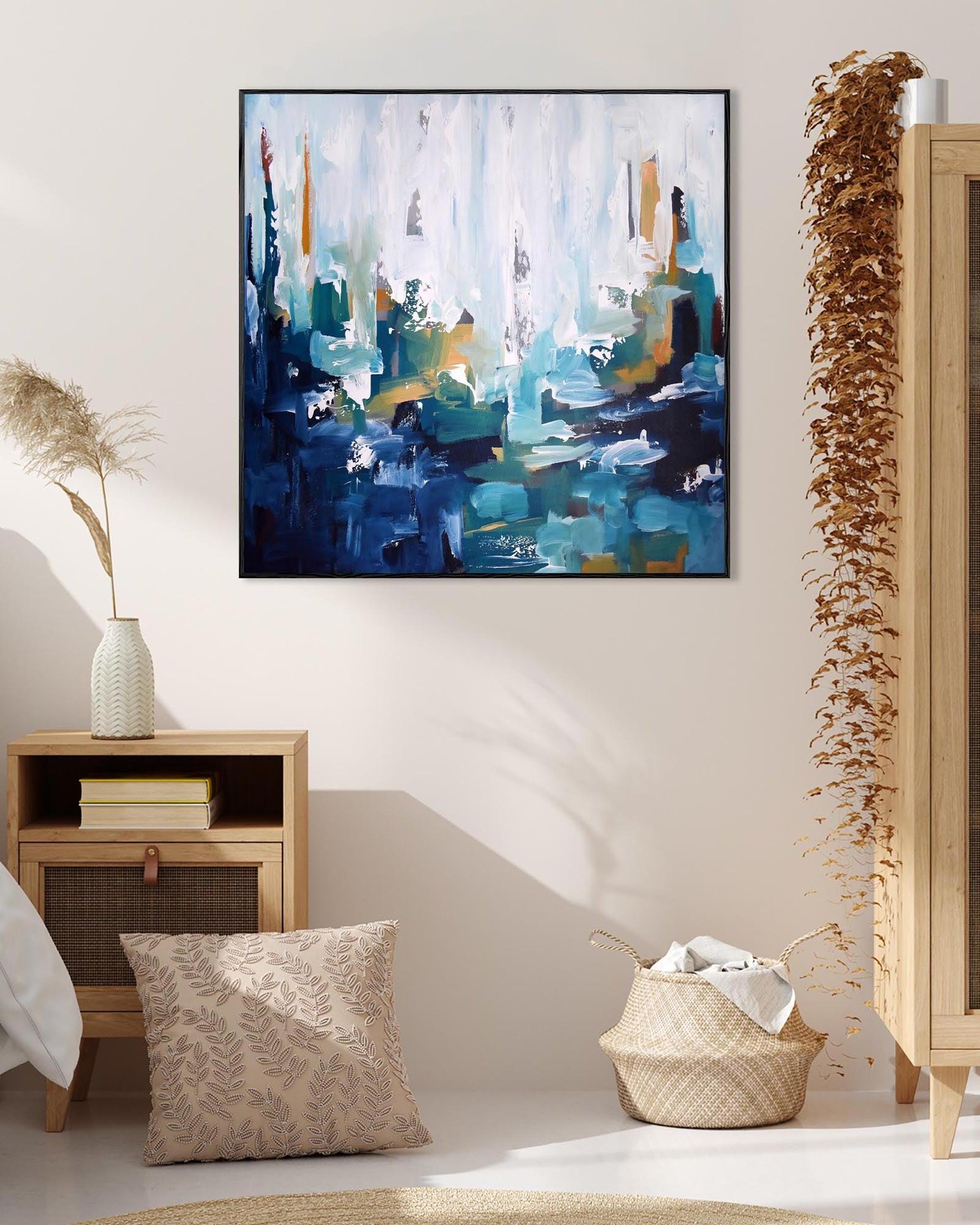 Abstract painting on a wall in a room with decor elements.