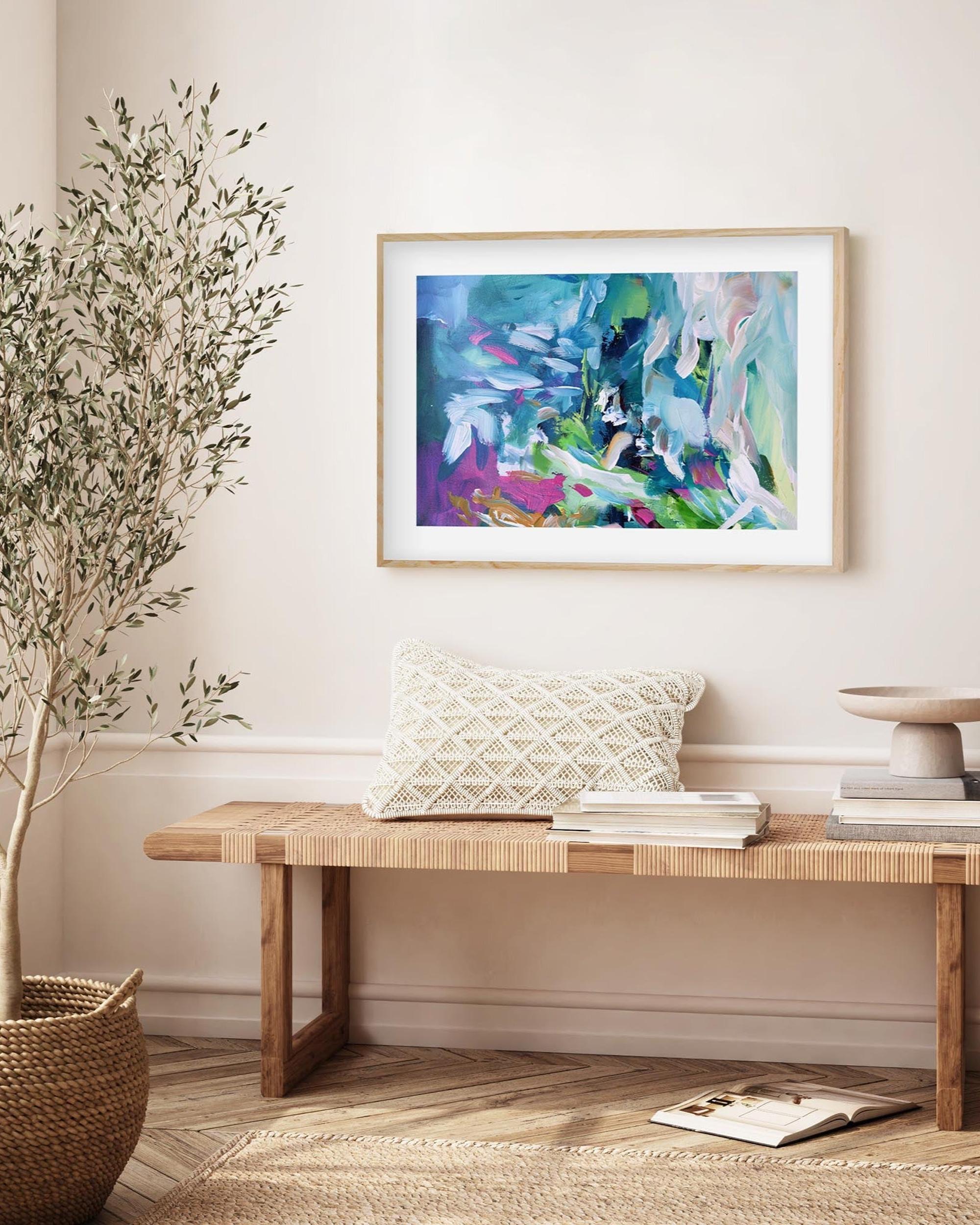 Living room with a wooden bench, decorative pillows, and a colorful abstract painting on the wall.