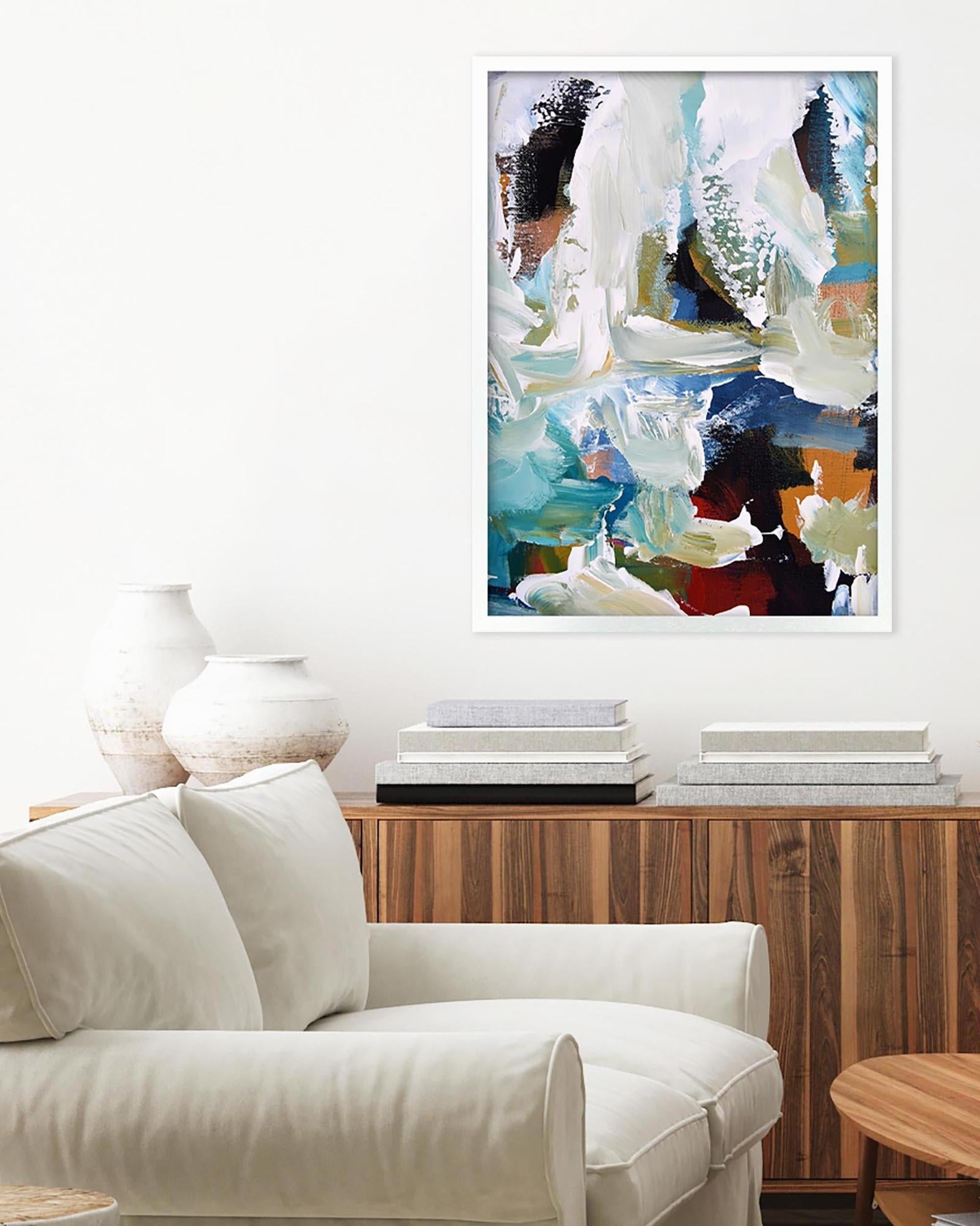 Modern living room with a white armchair, wooden cabinet, and abstract art on the wall.