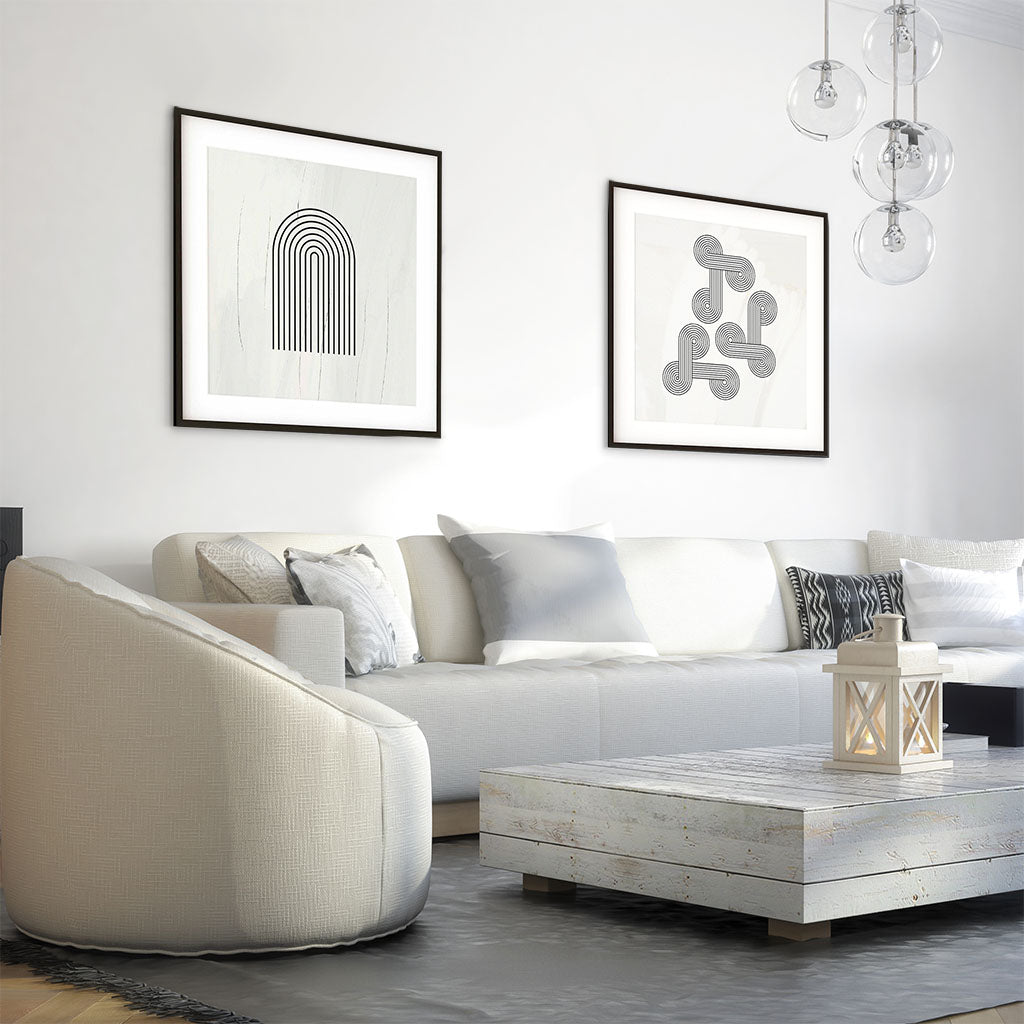 Modern living room with a white sofa, coffee table, and framed artwork on the wall.