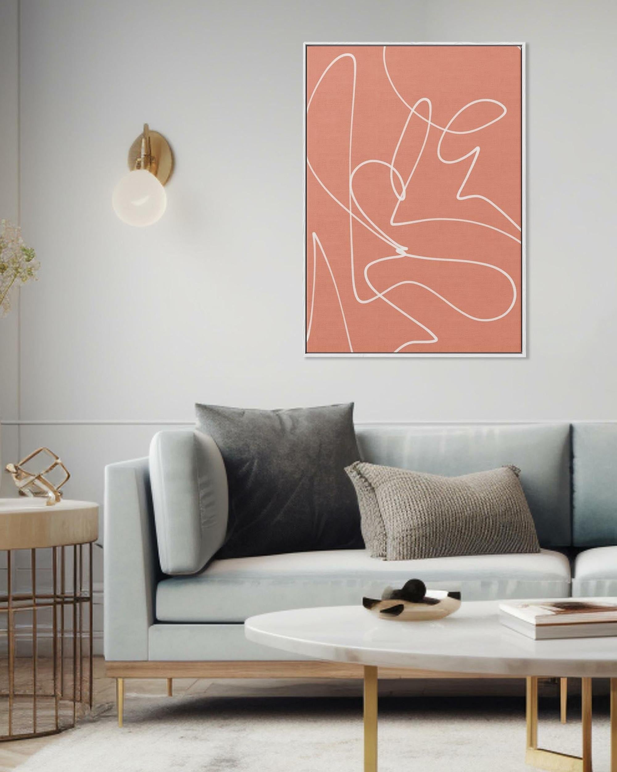 Modern living room with a gray sofa, coffee table, and abstract art on the wall.