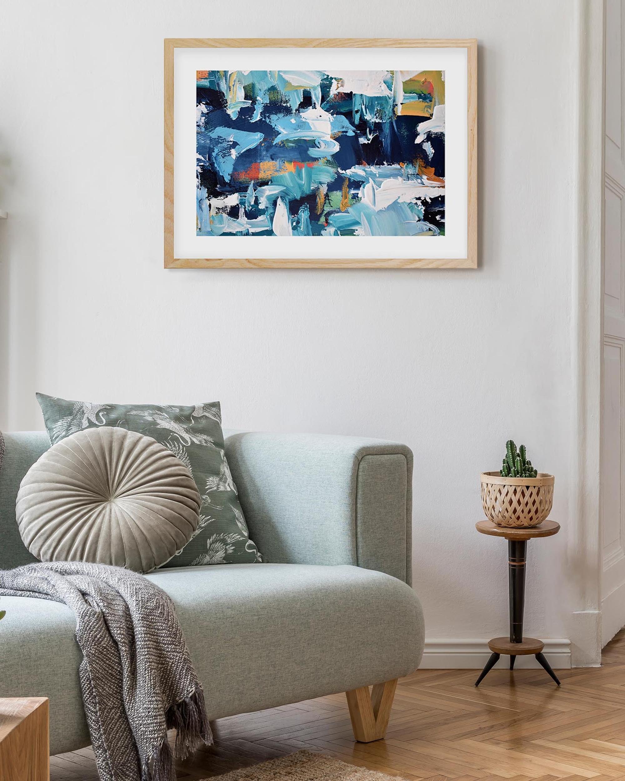framed art print abstract poster on a wall above a sofa in living room
