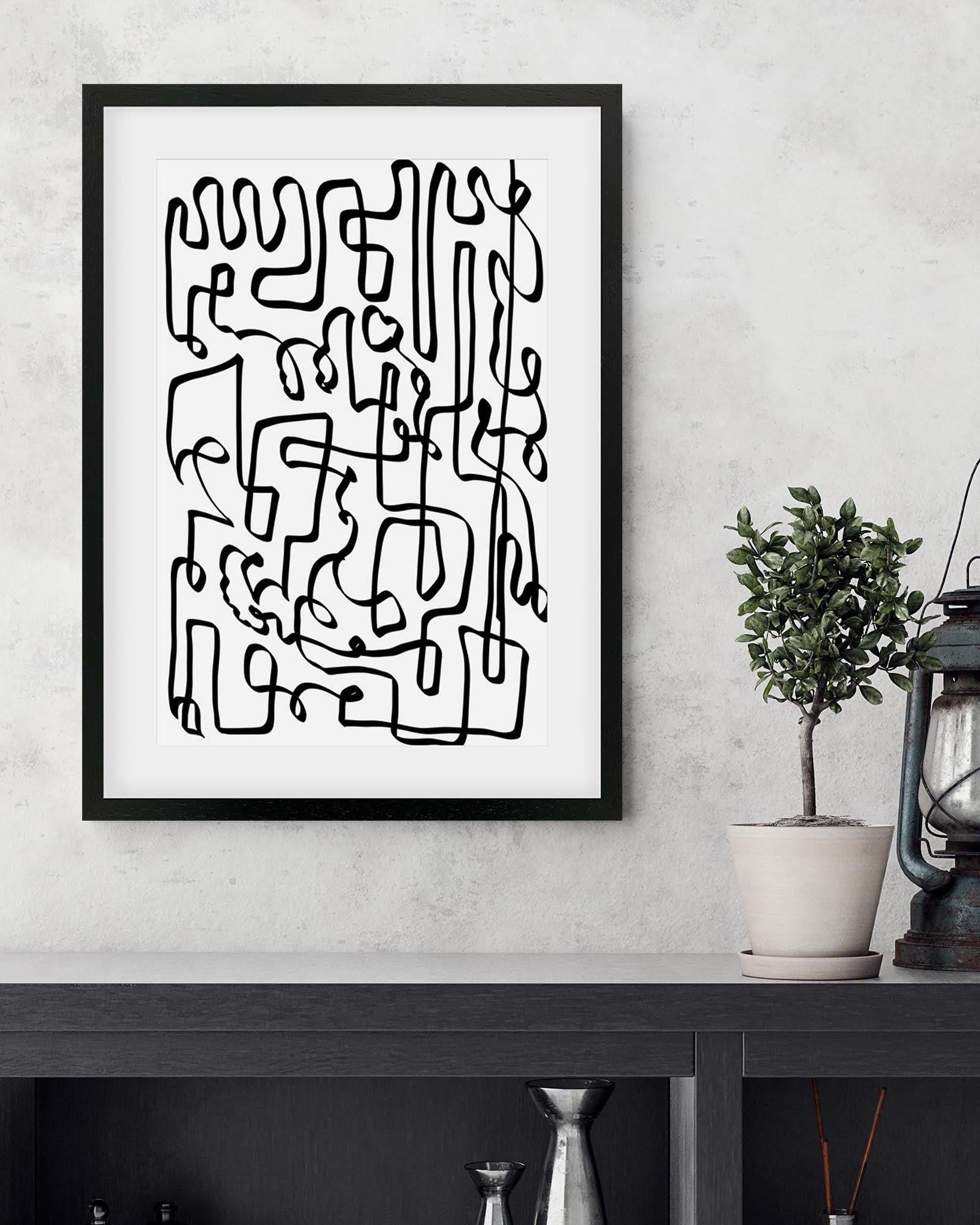 Framed abstract black line art on a white wall with a plant and lantern in the background.
