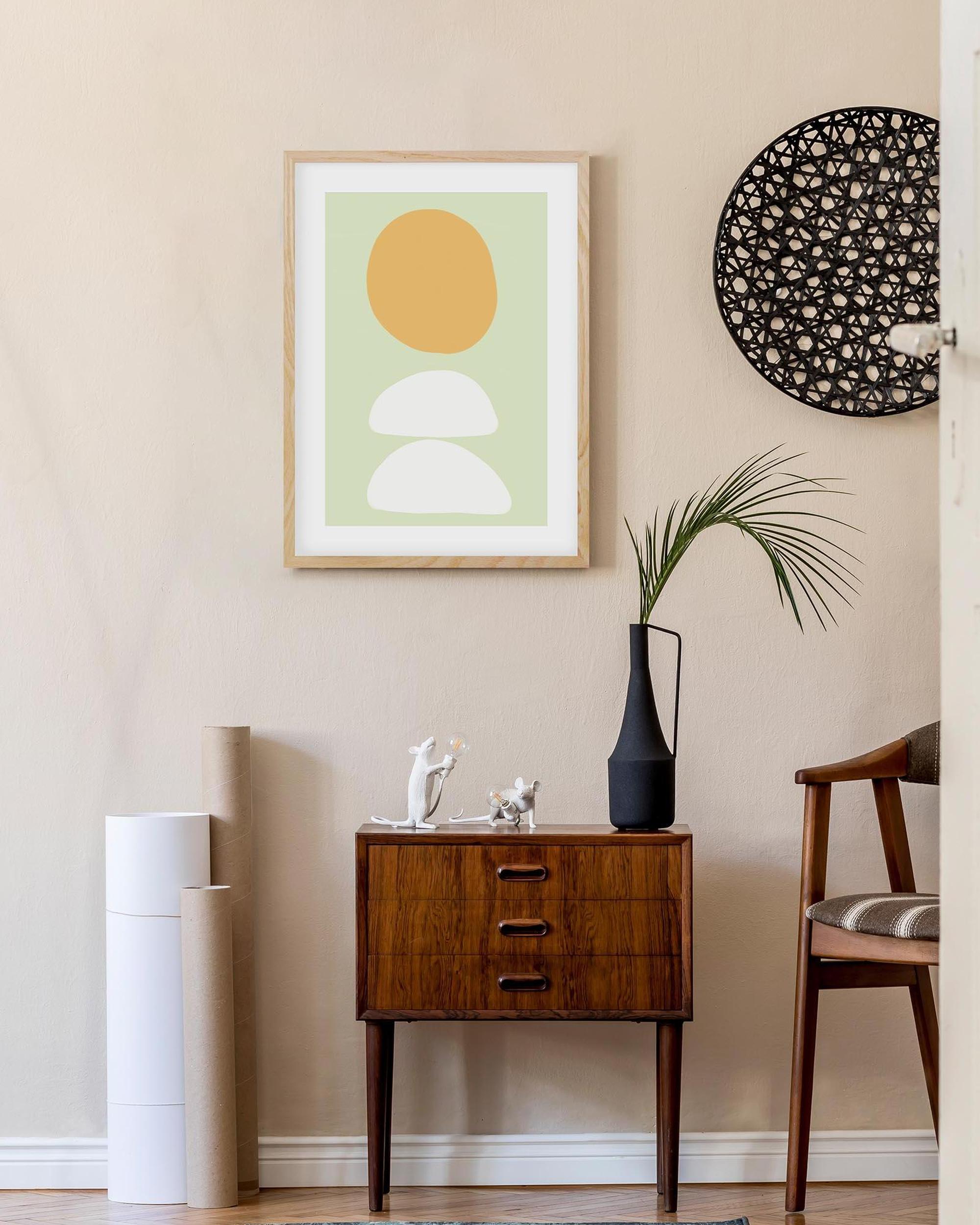 Modern interior with a wooden side table, abstract art, and decorative items.