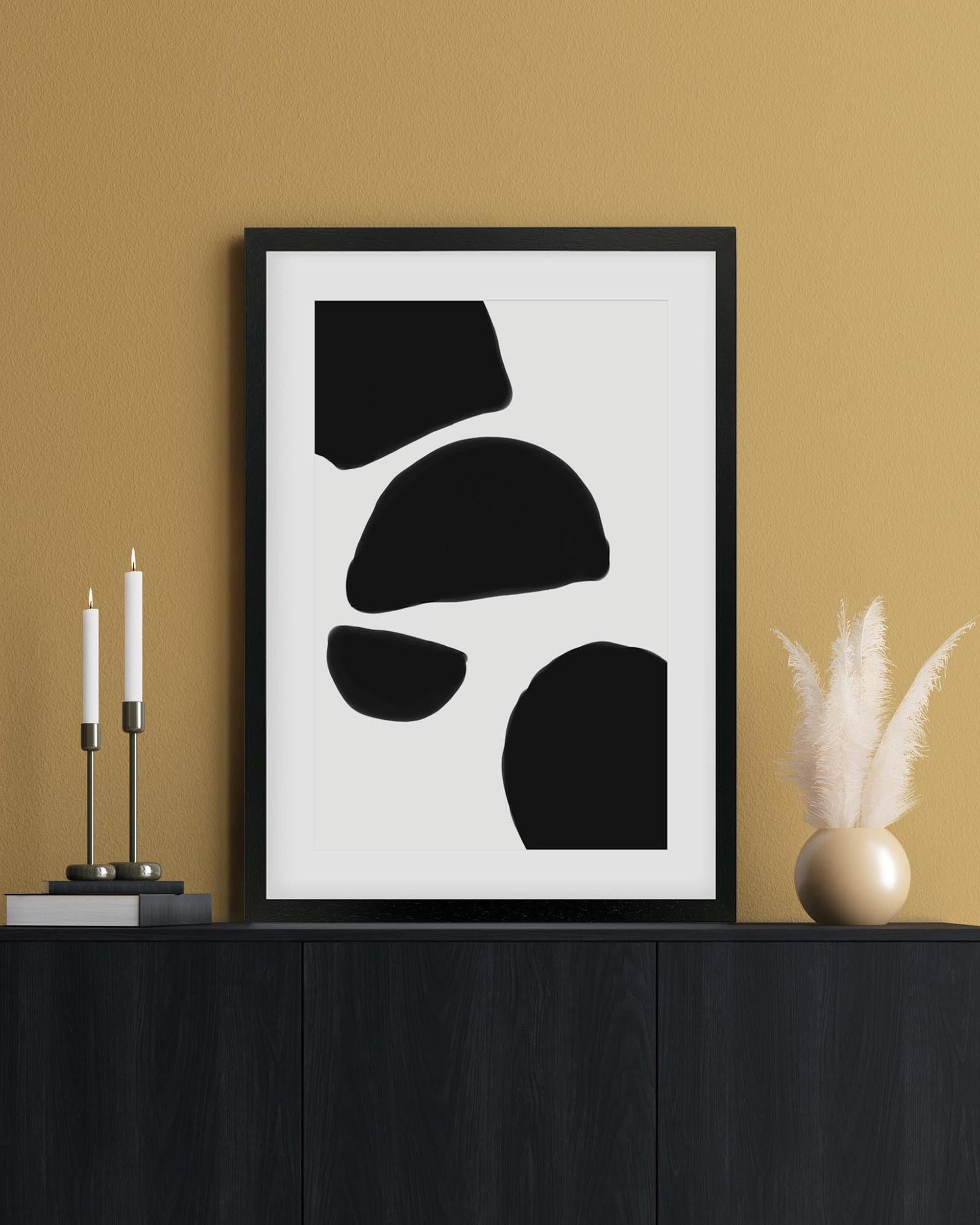 Framed abstract art print on a wall with candles and decor items.