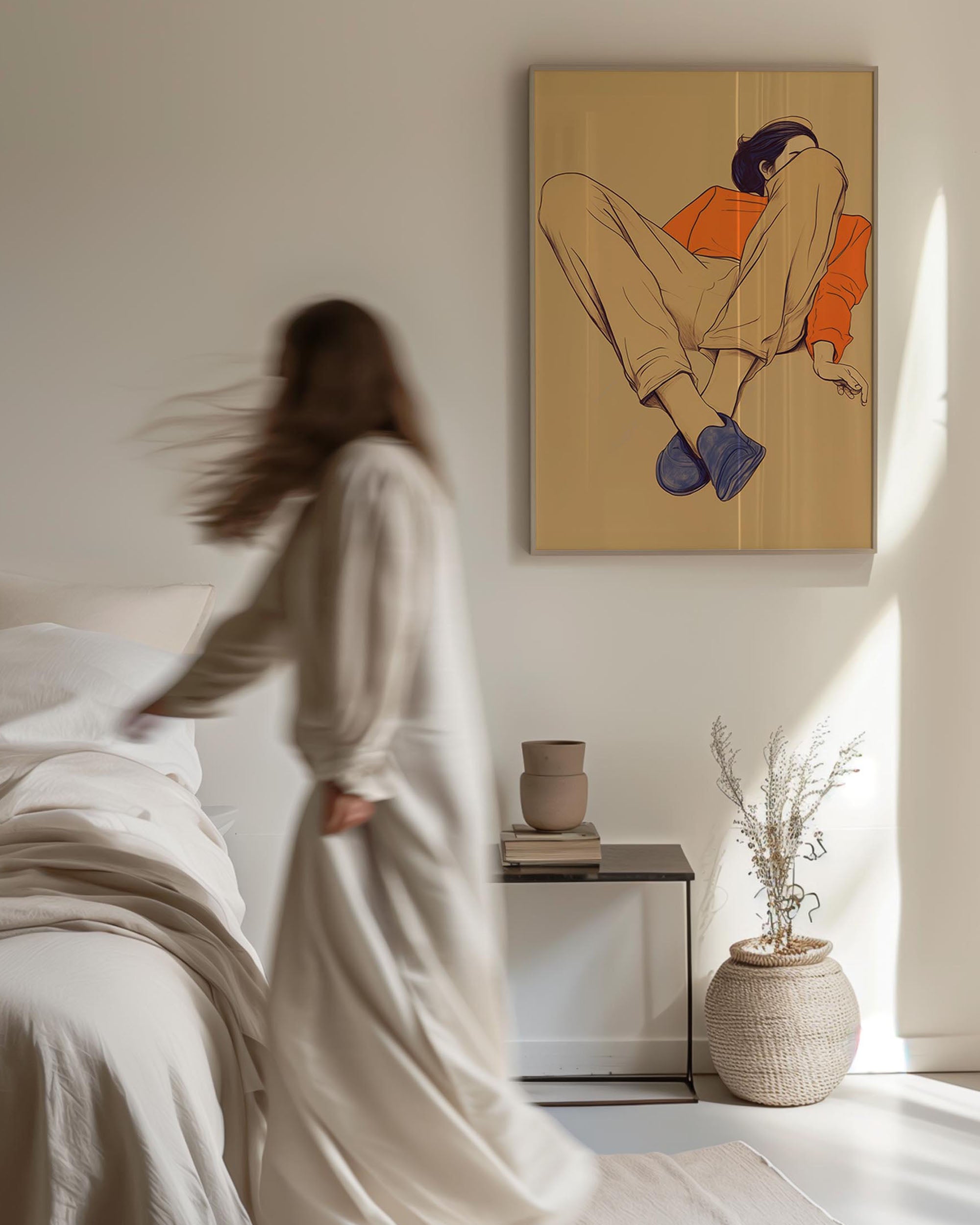 Woman in a white robe standing by a bed with a painting of a person on the wall.
