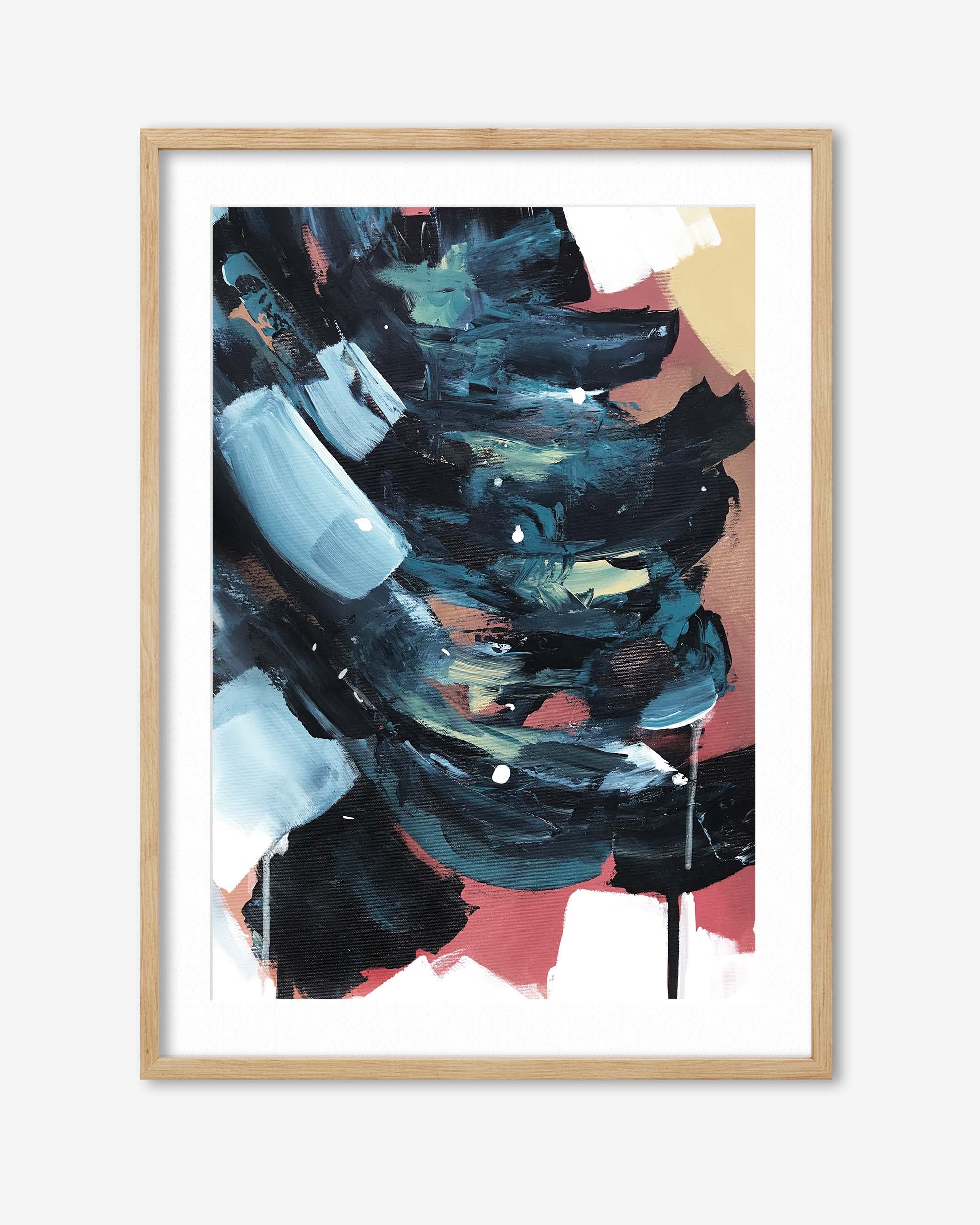 Abstract art print with bold colors in a wooden frame on a white background