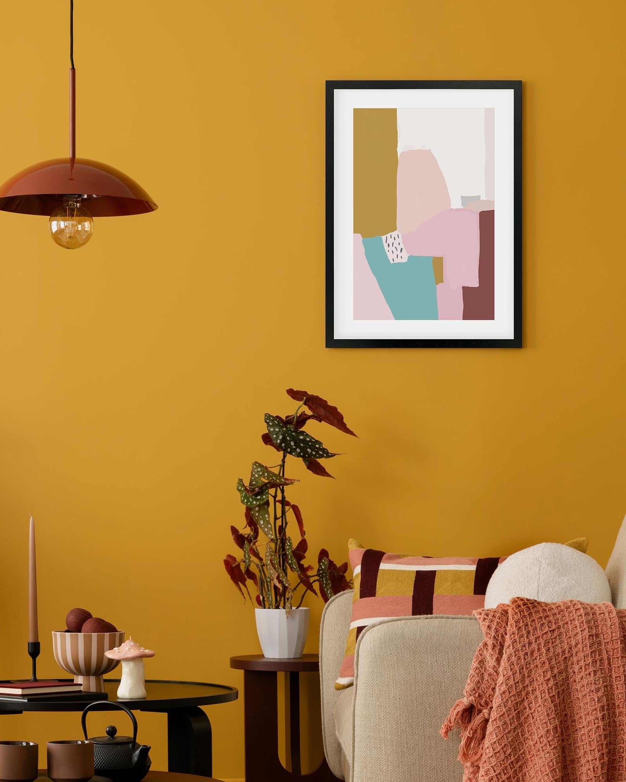 Living room with abstract art on a yellow wall, plant, and decorative items.