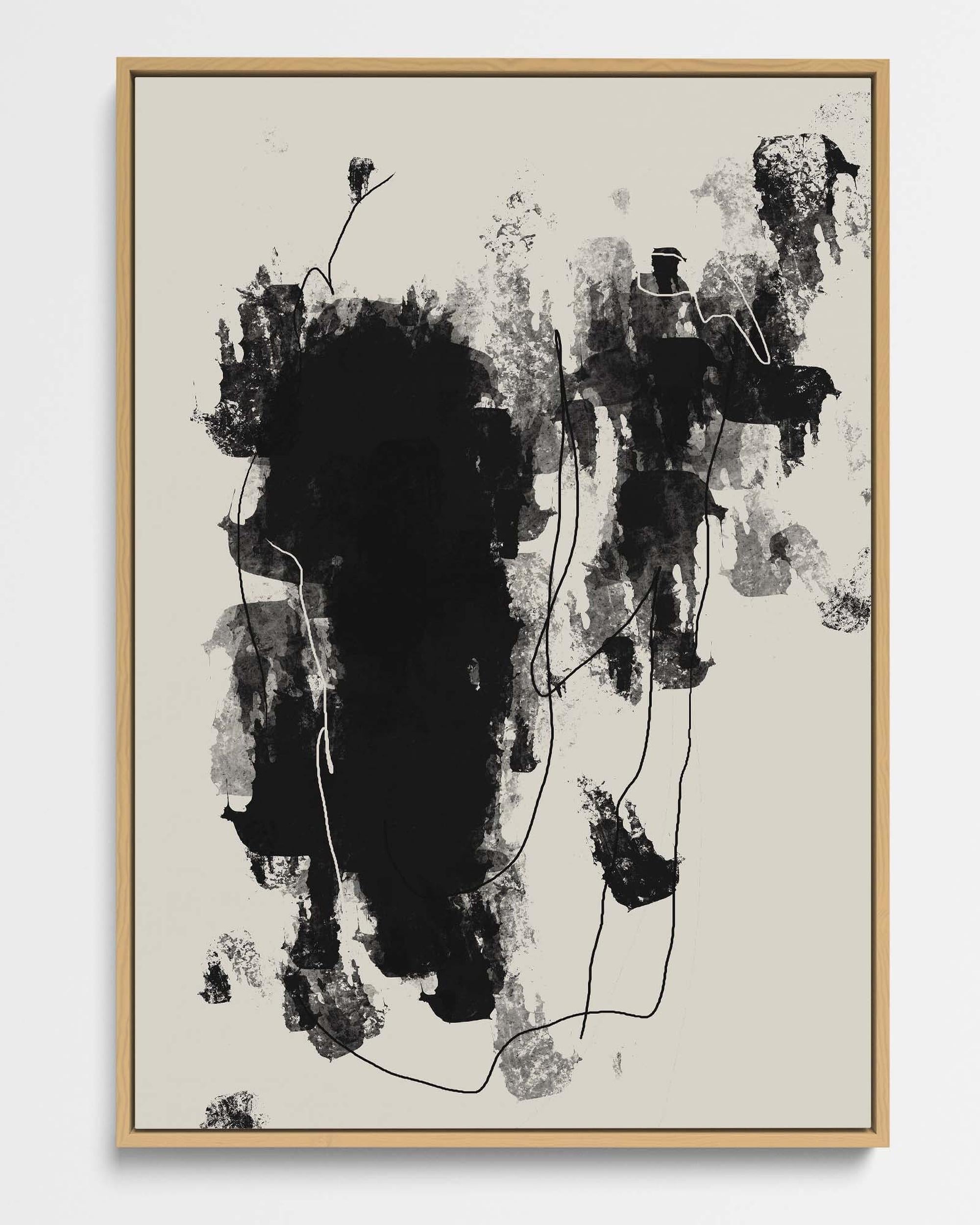 Abstract black and white artwork in a wooden frame on a beige background