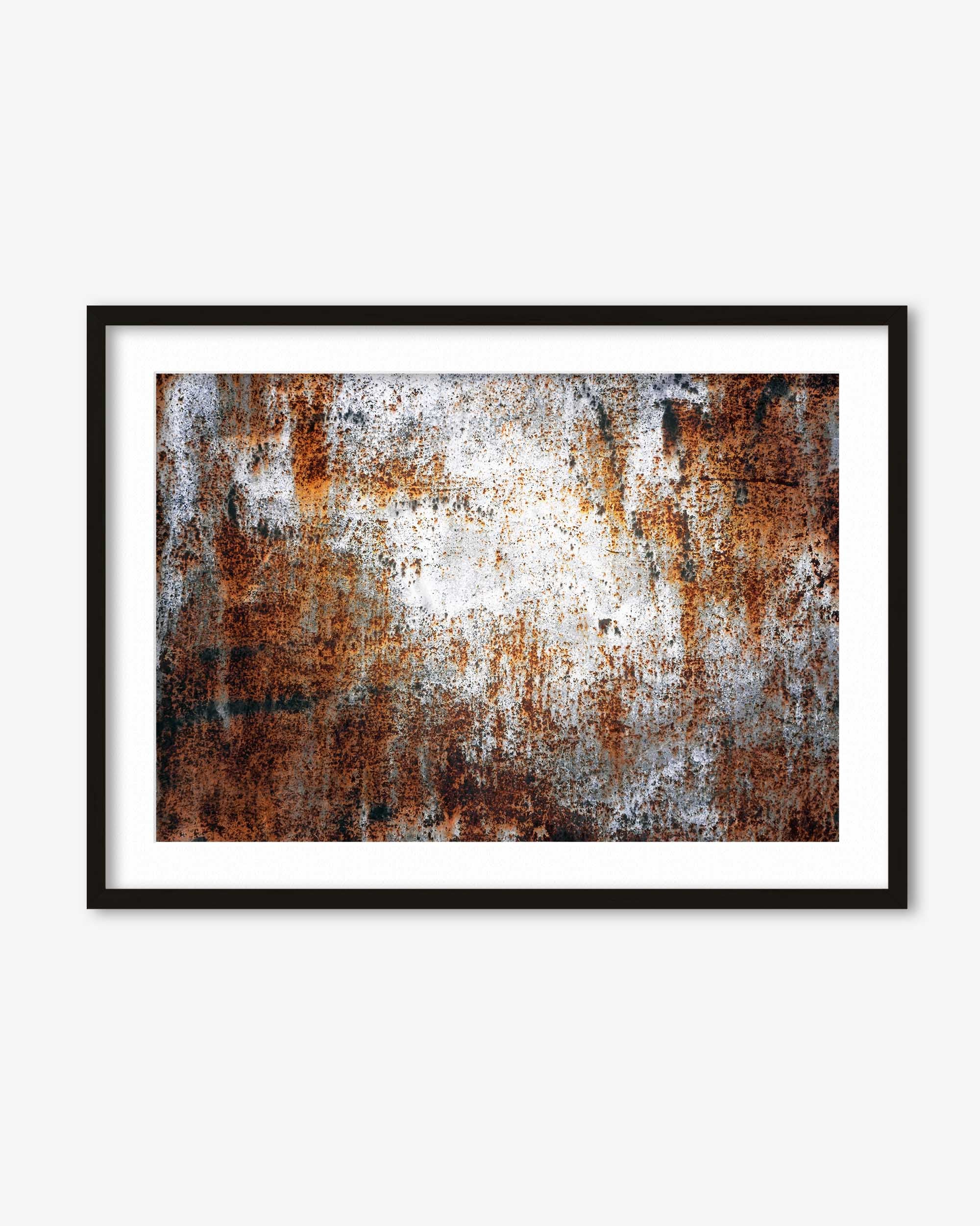 Framed abstract art with rust-like textures on a white background