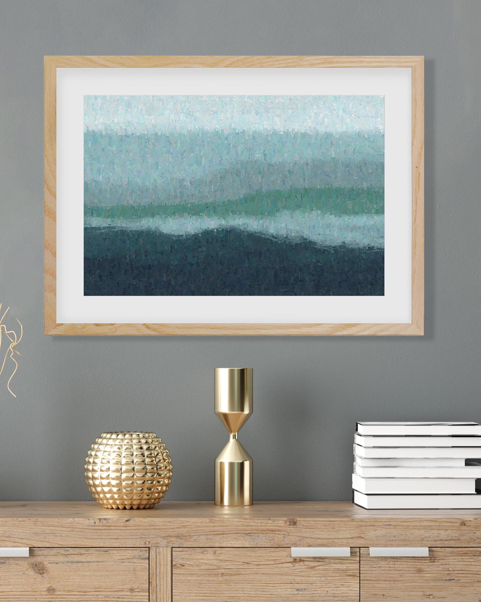 Framed abstract art piece on a gray wall with decorative items below.