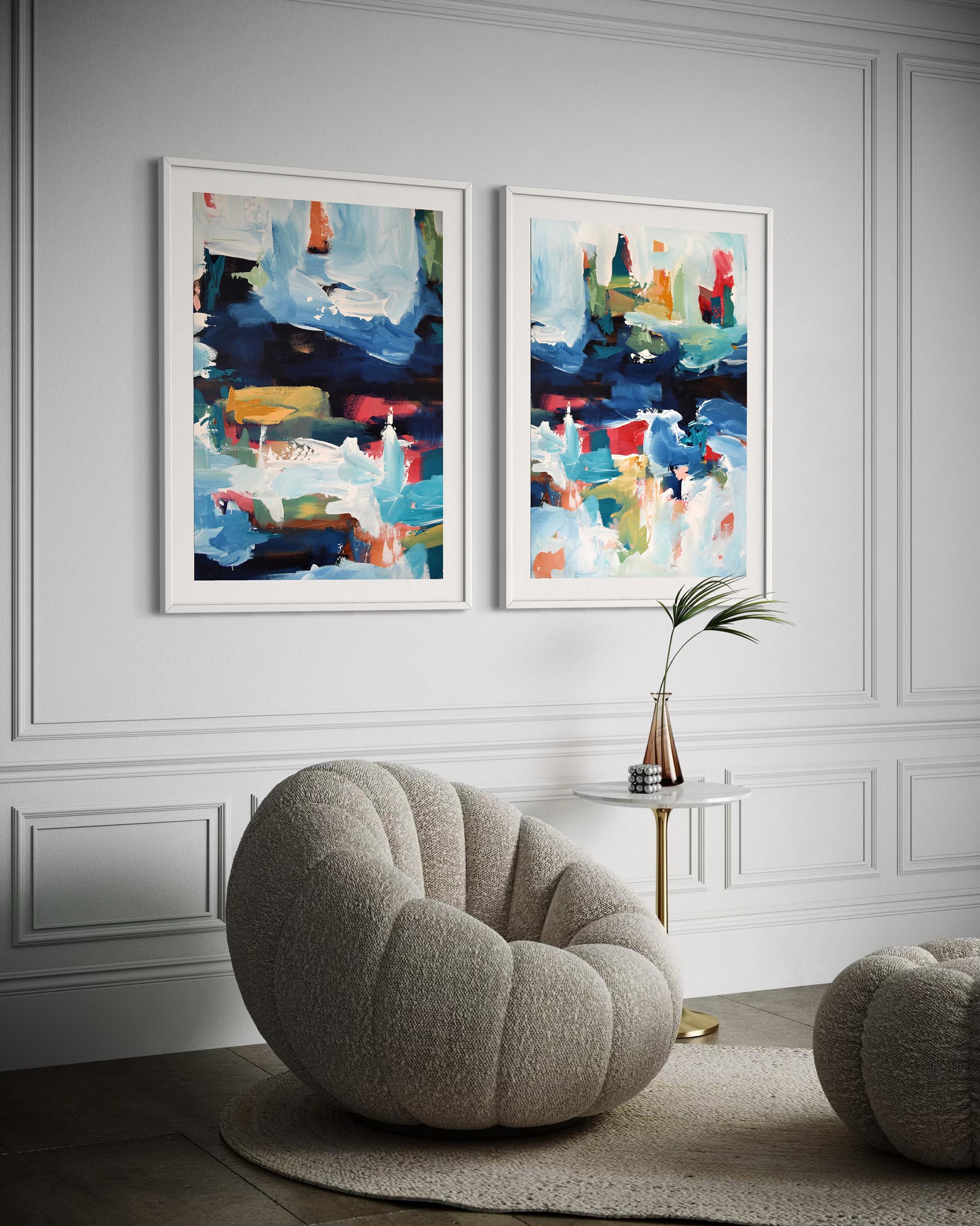 Two abstract paintings on a wall above a modern chair in a stylish room.