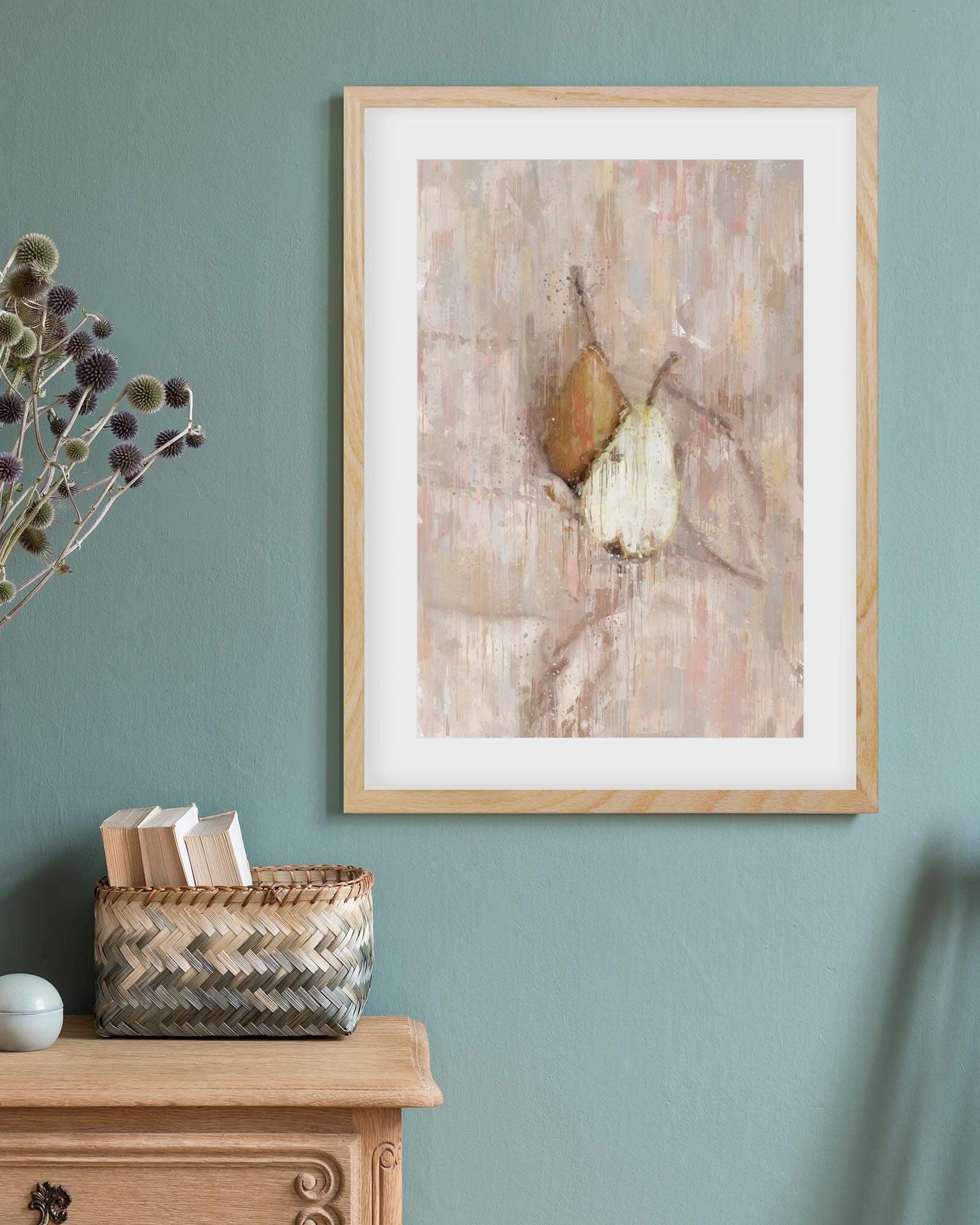 A Pair Of Pears framed print on a teal wall