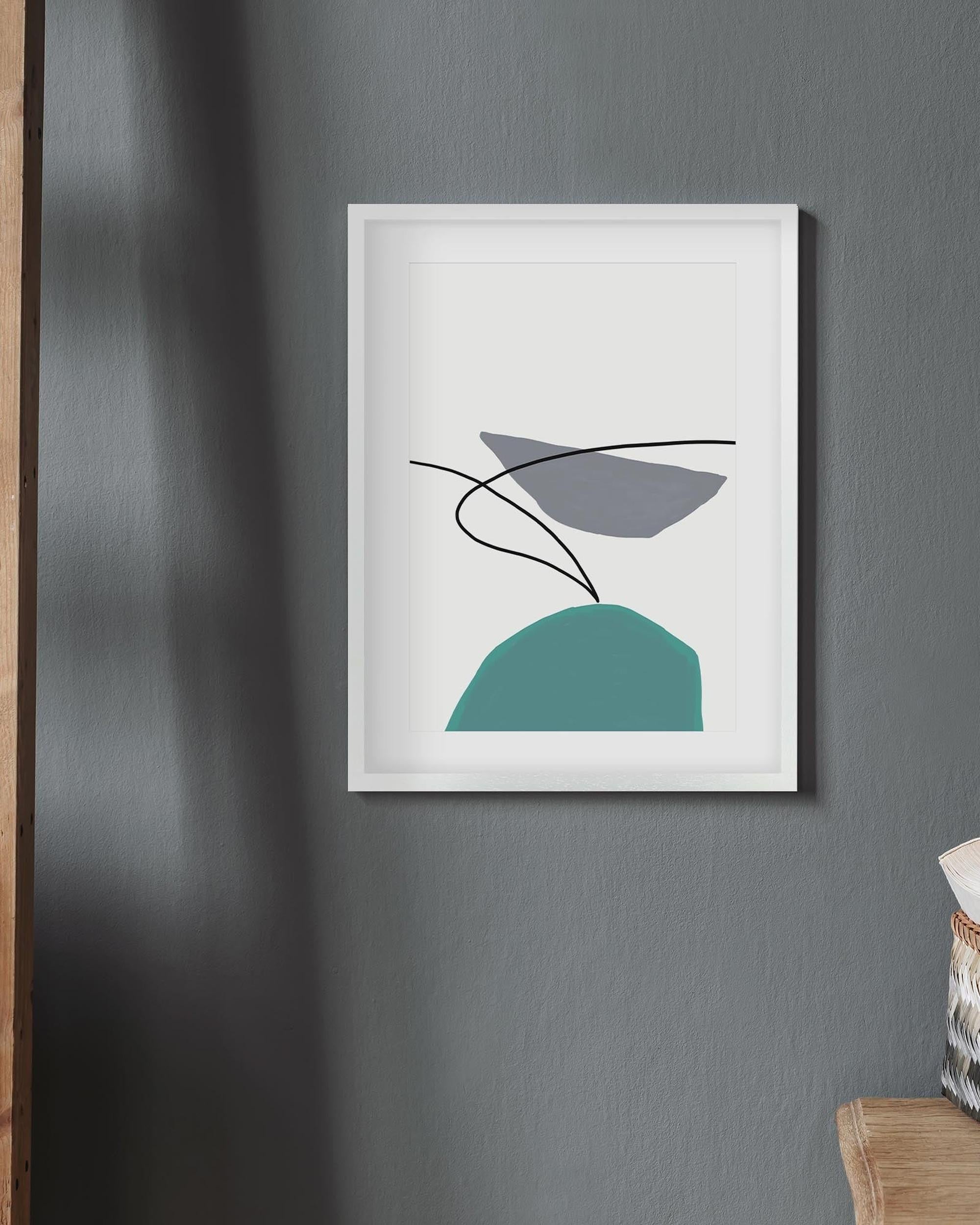 Framed abstract art piece on a gray wall