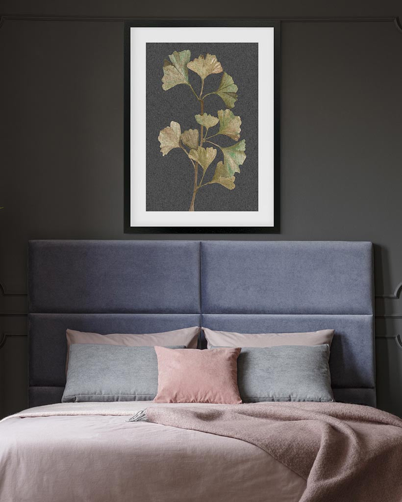 Bedroom with a blue headboard, pink and gray pillows, and a framed botanical print on the wall.