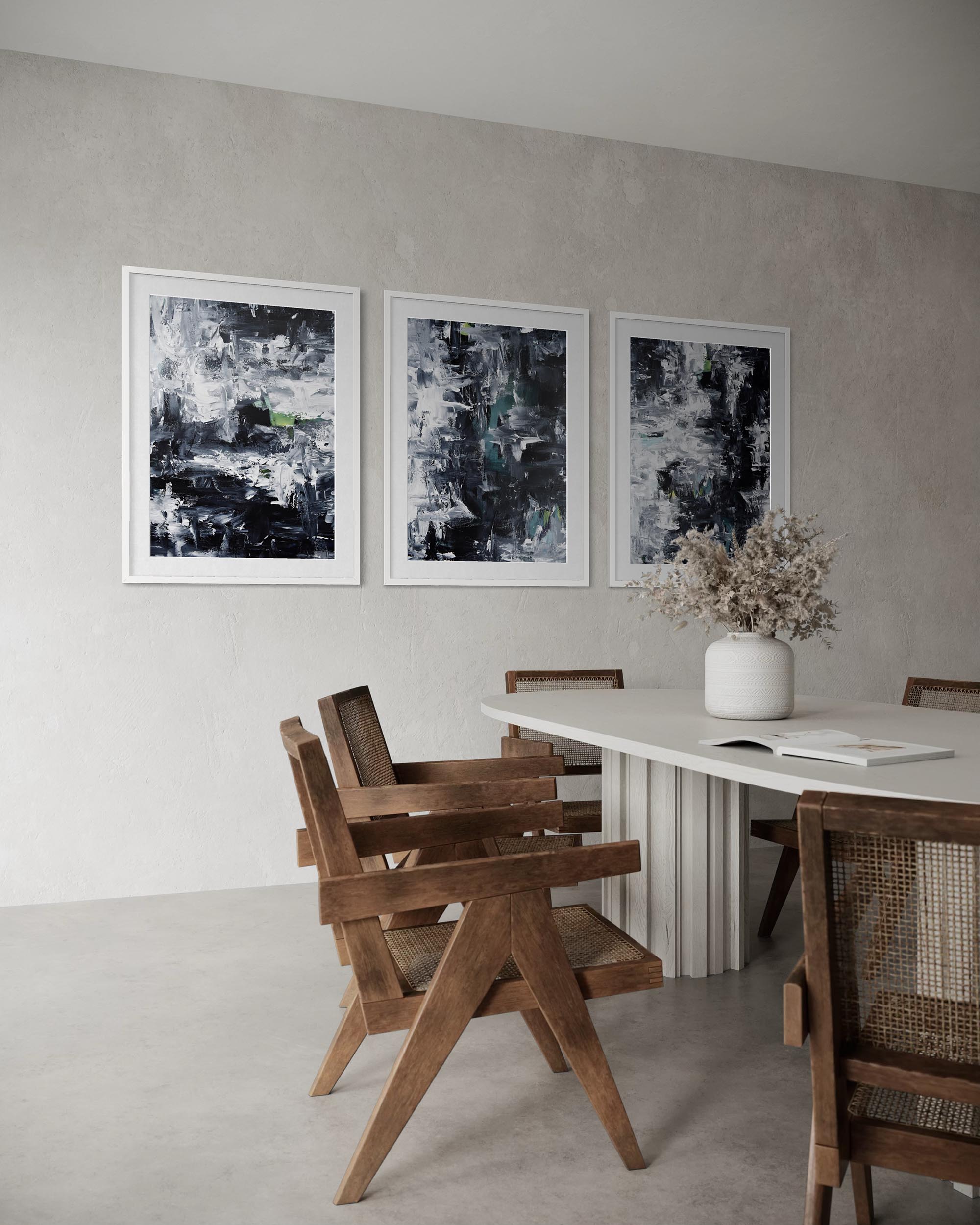 Dining room with wooden chairs and a white table, featuring abstract art on the wall.