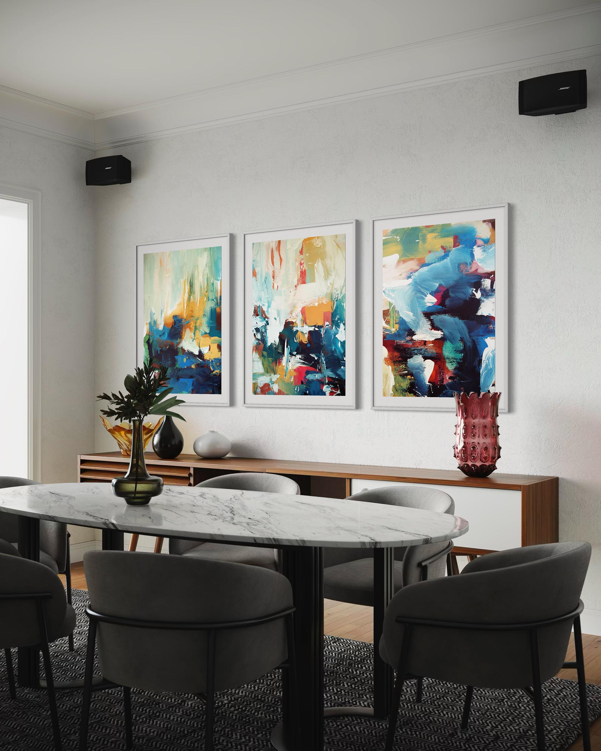 Dining room with marble table and gray chairs, featuring abstract art on the wall.