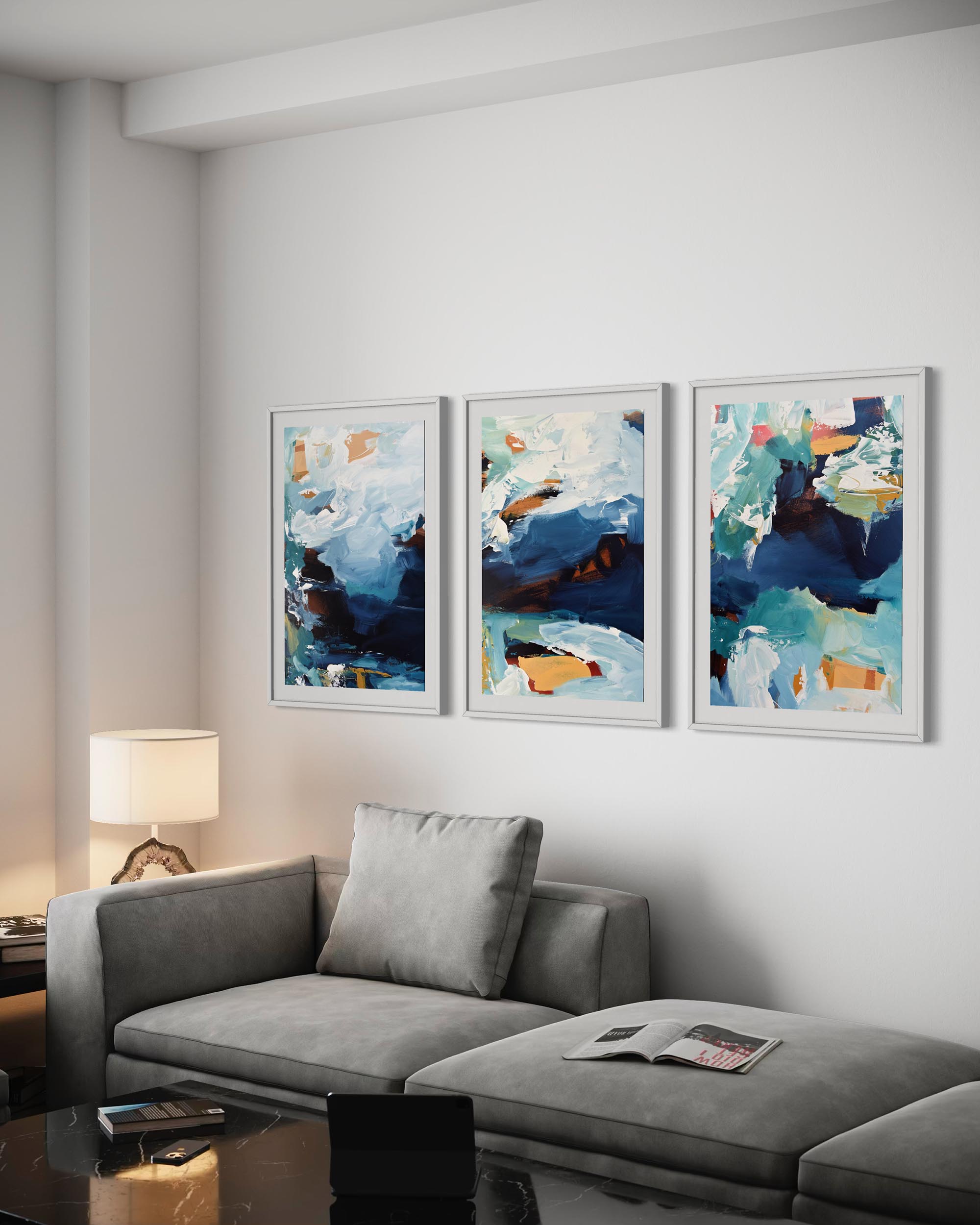 Living room with a gray sofa and three abstract art pieces on the wall.