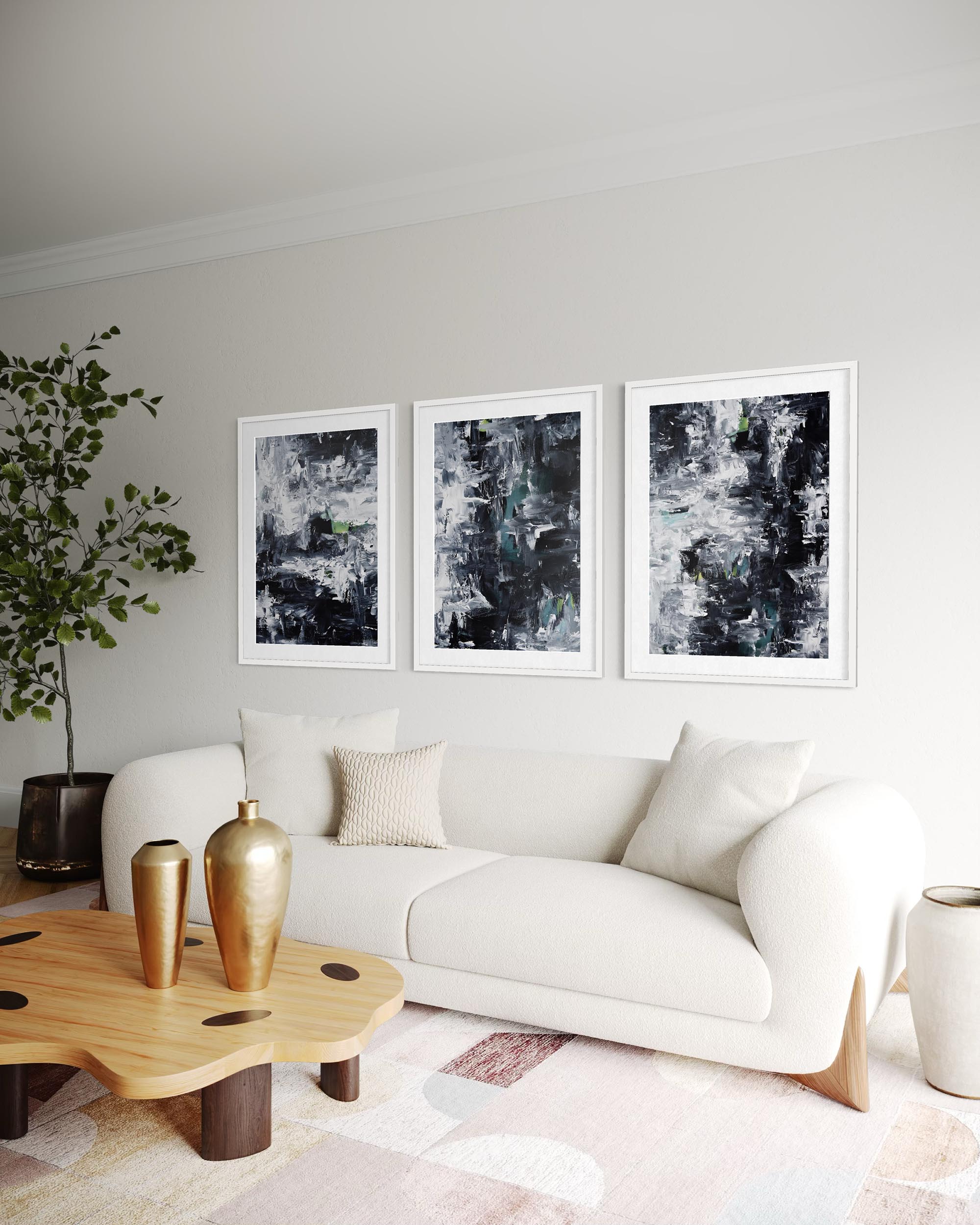 Modern living room with a white sofa, wooden coffee table, and abstract art on the wall.