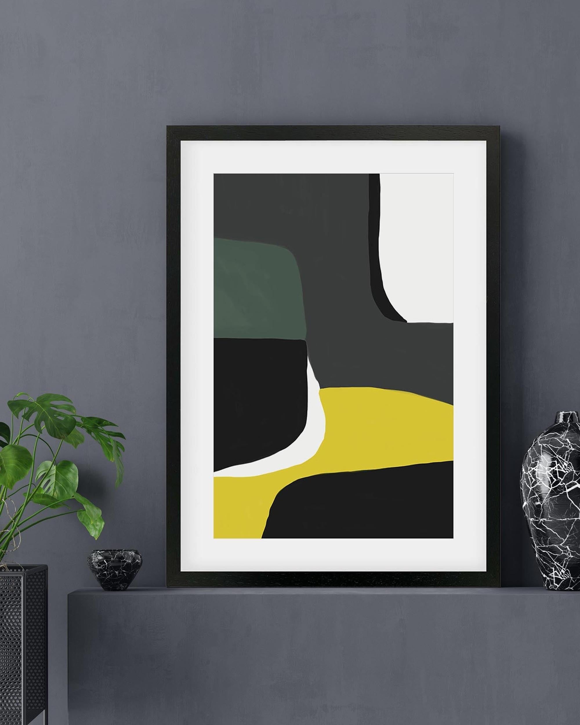 Framed abstract art piece on a dark wall with decorative elements.