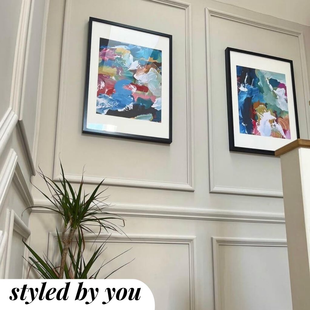 Framed prints hung on a wall