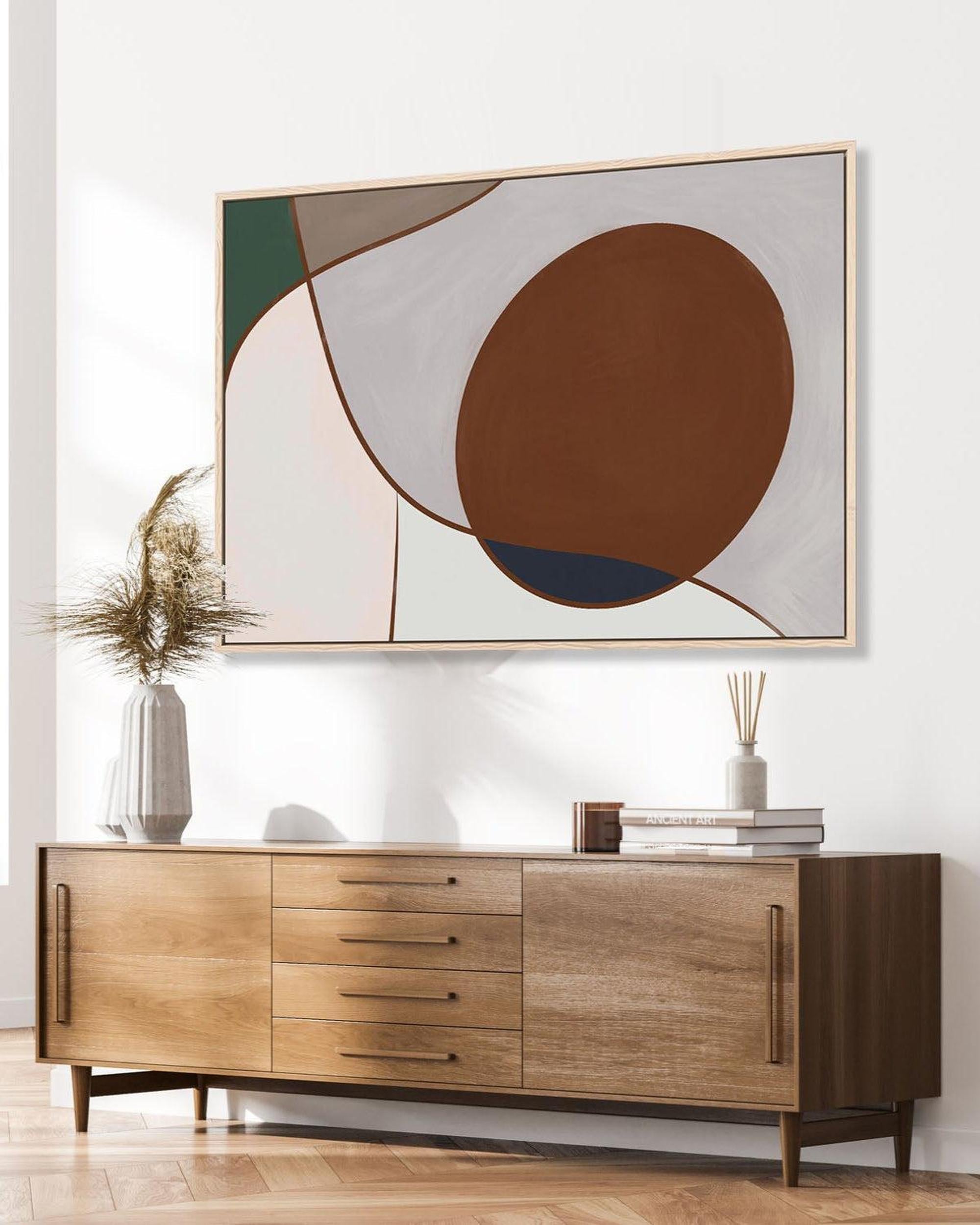 Wooden sideboard with abstract art on the wall