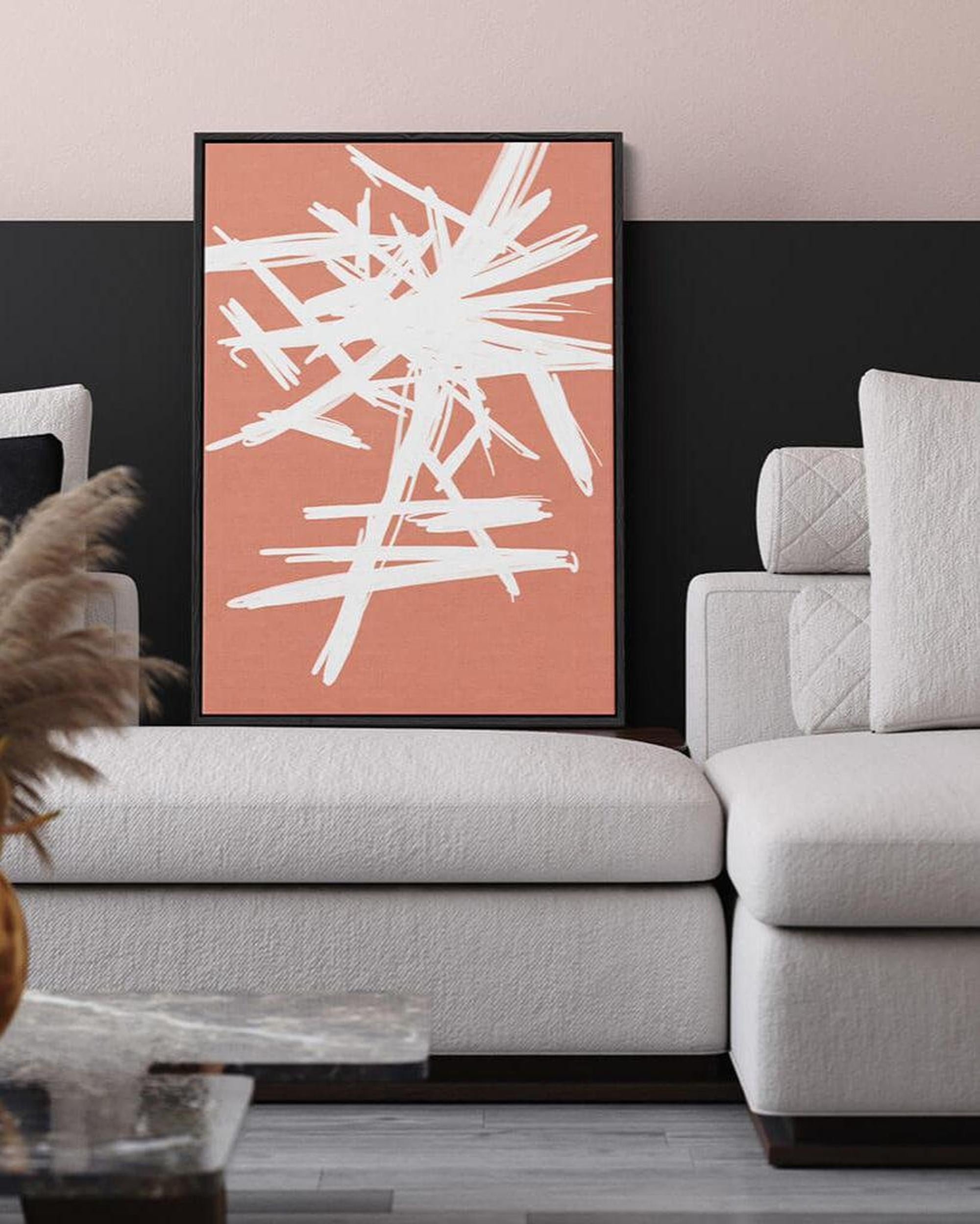 Modern living room with a gray sofa and abstract art on the wall.