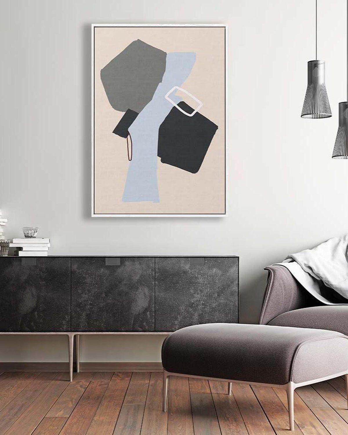 Modern living room with abstract art on the wall, gray sofa, and wooden floor.