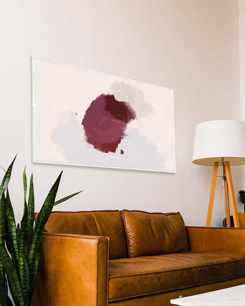 Brown leather sofa in a living room with a abstract painting on the wall.
