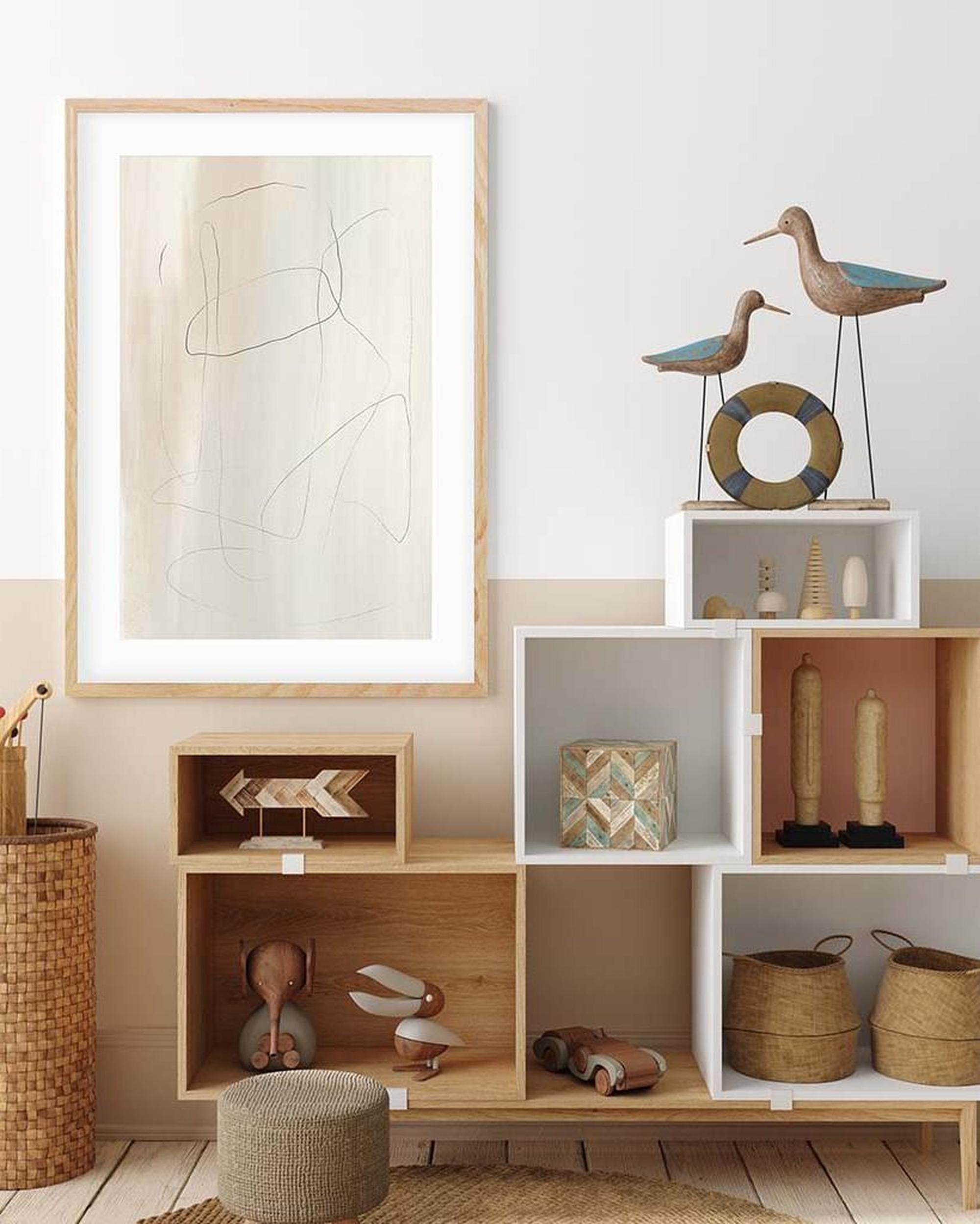 Decorative interior with shelves, framed artwork, and various decorative items.