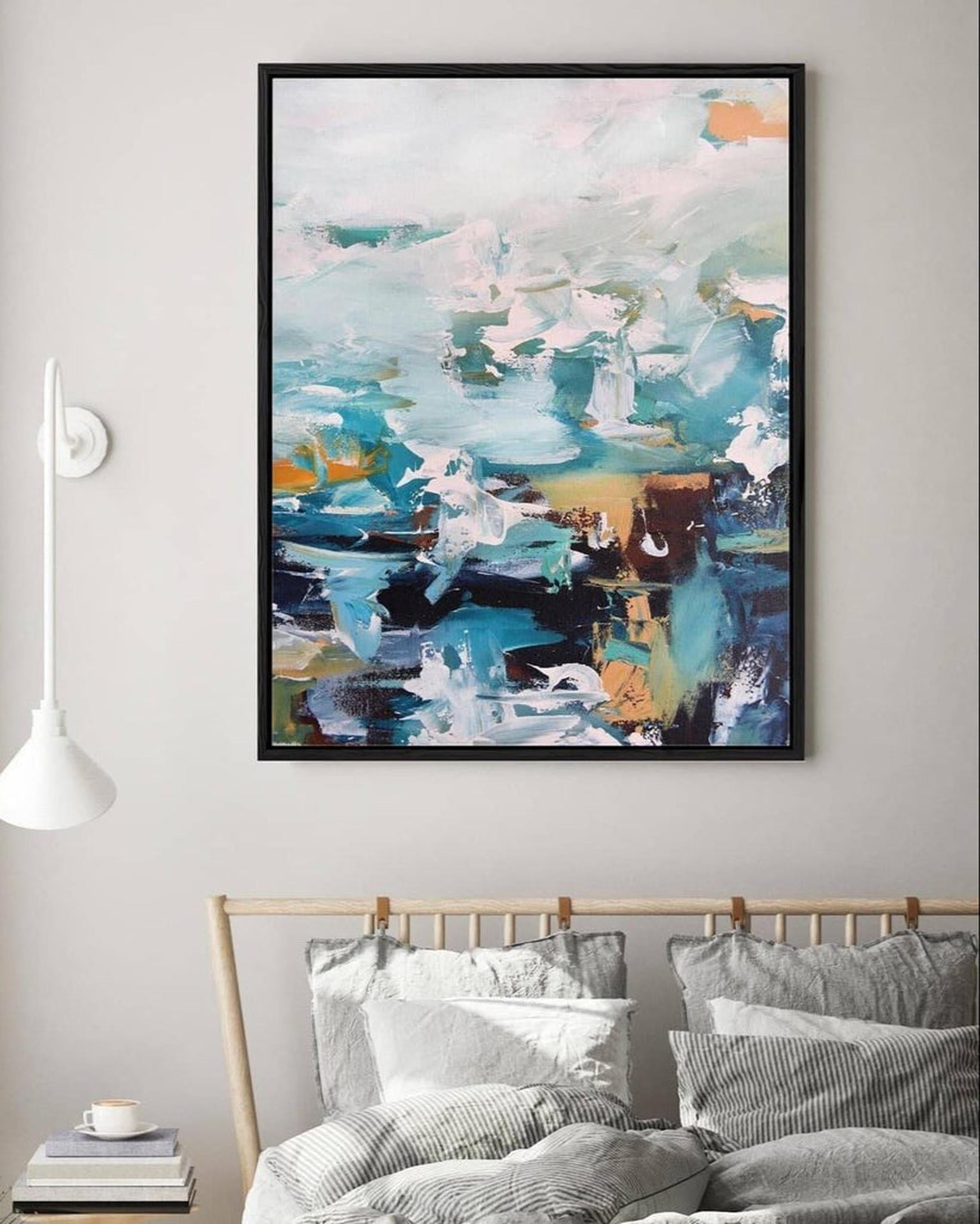 Abstract painting on a wall above a bed with striped bedding