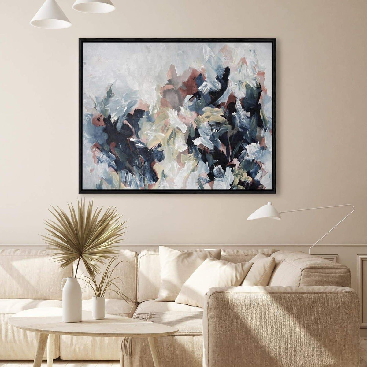 large abstract canvas wall art on a wall above a beige sofa in a living room